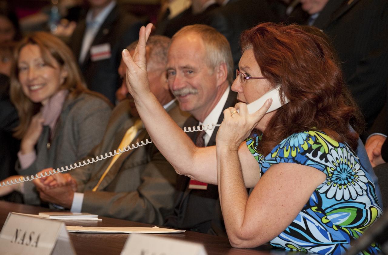 Anna-Marie Williams talks on the phone to her husband Expedition 21 with Flight Engineer Jeffrey N. Williams who is onboard the International Space Station (ISS) from the Mission Control Center Moscow in Korolev, Russia shortly after the successful docking of the Soyuz TMA-16 spacecraft with the International Space Station marking the start of Expedition 21 with Williams, Expedition 21 Flight Engineer Maxim Suraev, and Spaceflight Participant Guy Laliberté, Friday, Oct. 2, 2009. Photo Credit: (NASA/Bill Ingalls)