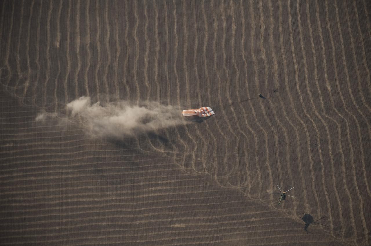 The Soyuz TMA-14 spacecraft is seen as it lands with Expedition 20 Commander Gennady Padalka, Flight Engineer Michael Barratt, and spaceflight participant Guy Laliberté near the town of Arkalyk, Kazakhstan on Sunday, Oct. 11, 2009. Padalka and Barratt are returning from six months onboard the International Space Station, along with Laliberté who arrived at the station on Oct. 2 with Expedition 21 Flight Engineers Jeff Williams and Maxim Suraev aboard the Soyuz TMA-16 spacecraft. Photo Credit: (NASA/Bill Ingalls)