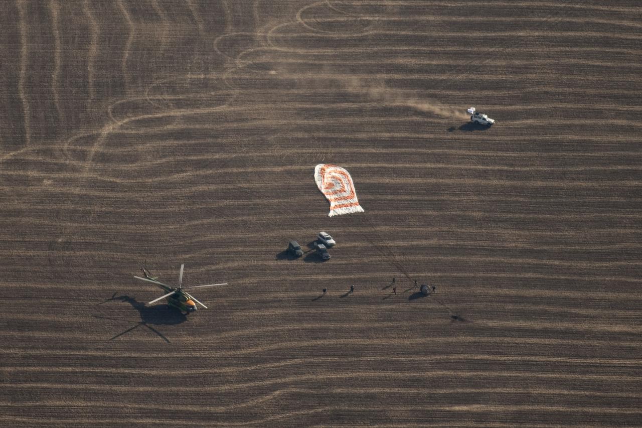 Russian Search and Rescue force vehicles and helicopter arrive within seconds of the Soyuz TMA-14 spacecraft landing with Expedition 20 Commander Gennady Padalka, Flight Engineer Michael Barratt, and spaceflight participant Guy Laliberté near the town of Arkalyk, Kazakhstan on Sunday, Oct. 11, 2009. Padalka and Barratt are returning from six months onboard the International Space Station, along with Laliberté who arrived at the station on Oct. 2 with Expedition 21 Flight Engineers Jeff Williams and Maxim Suraev aboard the Soyuz TMA-16 spacecraft. Photo Credit: (NASA/Bill Ingalls)