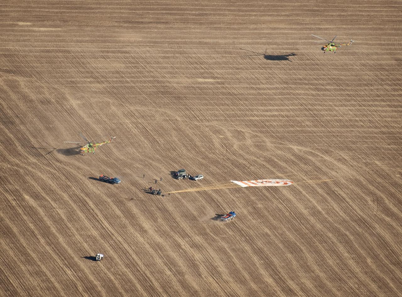 Russian Search and Rescue force vehicles and helicopter arrive within seconds of the Soyuz TMA-14 spacecraft landing with Expedition 20 Commander Gennady Padalka, Flight Engineer Michael Barratt, and spaceflight participant Guy Laliberté near the town of Arkalyk, Kazakhstan on Sunday, Oct. 11, 2009. Padalka and Barratt are returning from six months onboard the International Space Station, along with Laliberté who arrived at the station on Oct. 2 with Expedition 21 Flight Engineers Jeff Williams and Maxim Suraev aboard the Soyuz TMA-16 spacecraft. Photo Credit: (NASA/Bill Ingalls)