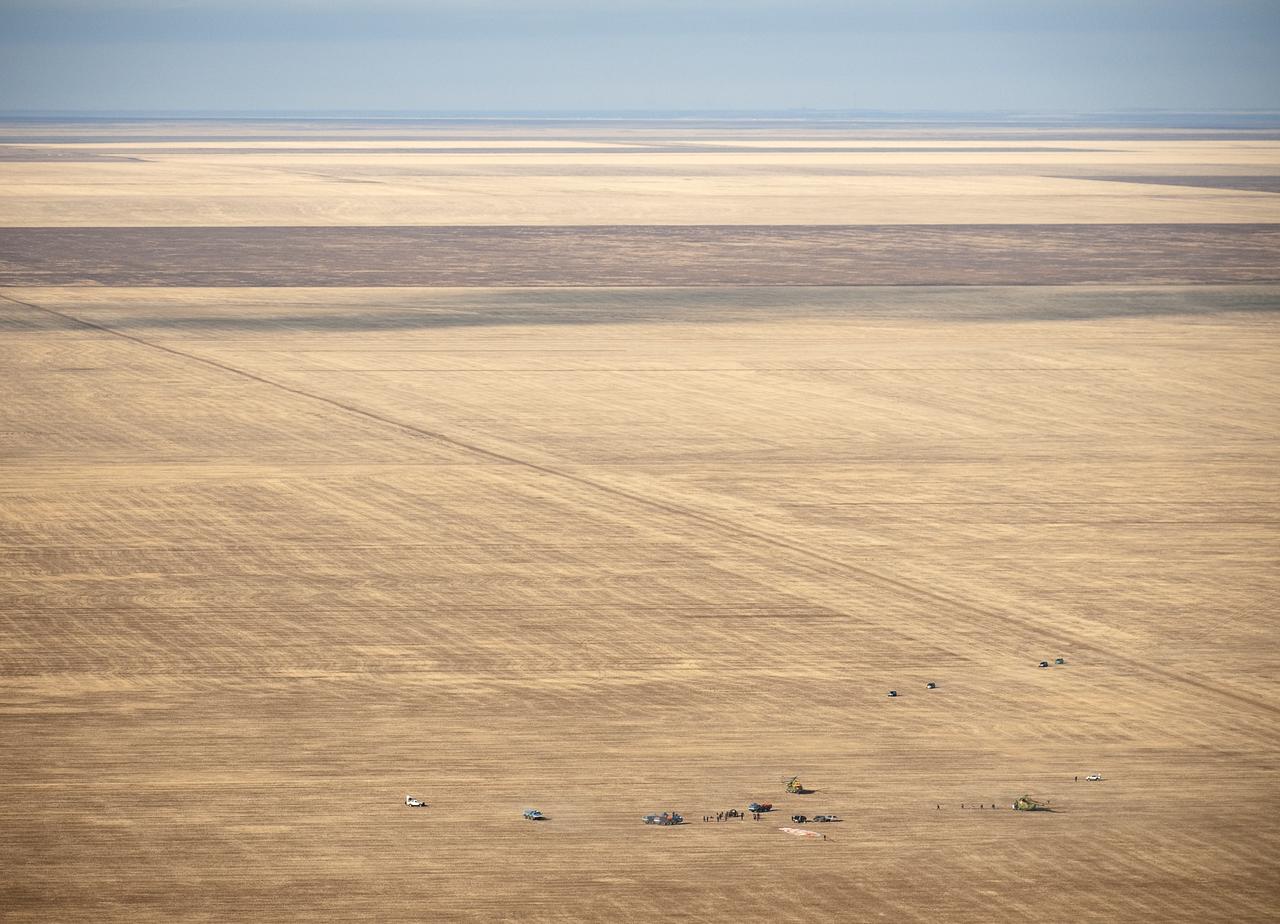 Russian Search and Rescue force vehicles and helicopter arrive within seconds of the Soyuz TMA-14 spacecraft landing with Expedition 20 Commander Gennady Padalka, Flight Engineer Michael Barratt, and spaceflight participant Guy Laliberté near the town of Arkalyk, Kazakhstan on Sunday, Oct. 11, 2009. Padalka and Barratt are returning from six months onboard the International Space Station, along with Laliberté who arrived at the station on Oct. 2 with Expedition 21 Flight Engineers Jeff Williams and Maxim Suraev aboard the Soyuz TMA-16 spacecraft. Photo Credit: (NASA/Bill Ingalls)