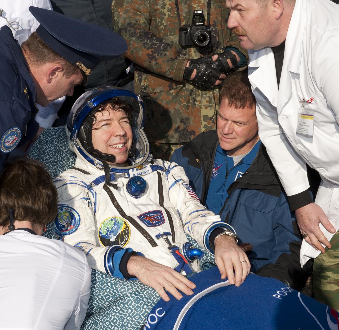 Expedition 20 Flight Engineer Michael Barratt rests in a chair shortly after he and Spaceflight participant Guy Laliberté, and Expedition 20 Commander Gennady Padalka landed in their Soyuz TMA-14 capsule near the town of Arkalyk, Kazakhstan on Sunday, Oct. 11, 2009. Padalka and Barratt are returning from six months onboard the International Space Station, along with Laliberté who arrived at the station on Oct. 2 with Expedition 21 Flight Engineers Jeff Williams and Maxim Suraev aboard the Soyuz TMA-16 spacecraft.  Photo Credit: (NASA/Bill Ingalls)