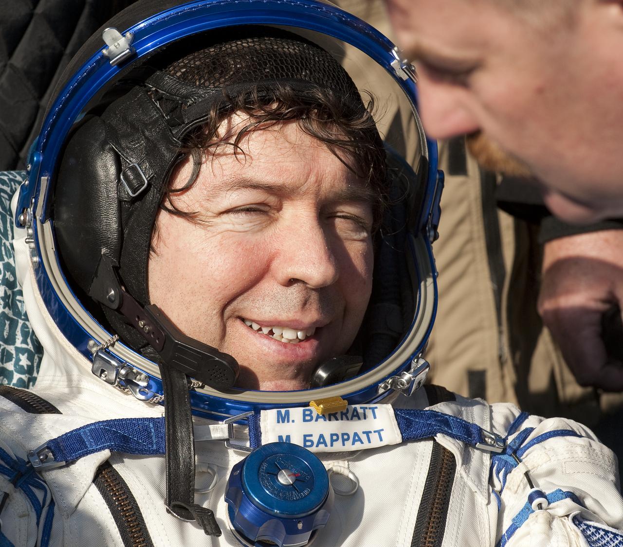 Expedition 20 Flight Engineer Michael Barratt rests in a chair shortly after he and Spaceflight participant Guy Laliberté, and Expedition 20 Commander Gennady Padalka landed in their Soyuz TMA-14 capsule near the town of Arkalyk, Kazakhstan on Sunday, Oct. 11, 2009. Padalka and Barratt are returning from six months onboard the International Space Station, along with Laliberté who arrived at the station on Oct. 2 with Expedition 21 Flight Engineers Jeff Williams and Maxim Suraev aboard the Soyuz TMA-16 spacecraft.  Photo Credit: (NASA/Bill Ingalls)