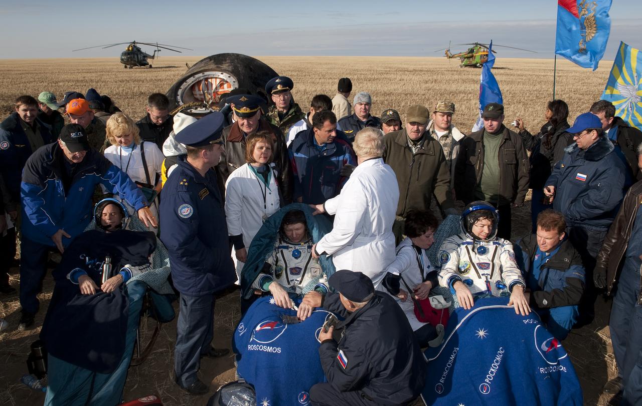 Seated left to right, Spaceflight participant Guy Laliberté, Expedition 20 Commander Gennady Padalka, Expedition 20 Flight Engineer Michael Barratt sit in chairs outside the Soyuz Capsule just minutes they landed near the town of Arkalyk, Kazakhstan on Sunday, Oct. 11, 2009. Padalka and Barratt are returning from six months onboard the International Space Station, along with Laliberté who arrived at the station on Oct. 2 with Expedition 21 Flight Engineers Jeff Williams and Maxim Suraev aboard the Soyuz TMA-16 spacecraft.  Photo Credit: (NASA/Bill Ingalls)