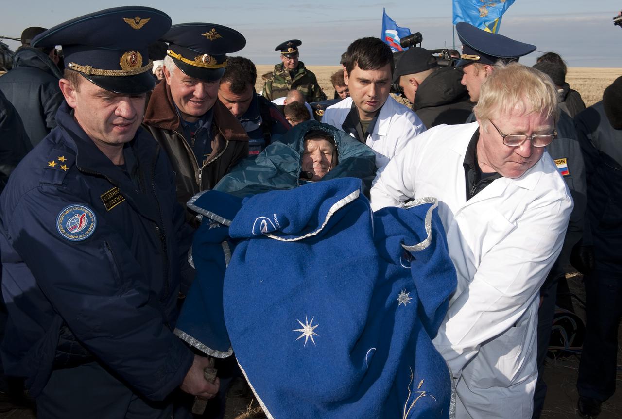 Expedition 20 Commander Gennady Padalka is carried in a chair to the medical tent shortly after he and Spaceflight participant Guy Laliberté, and Expedition 20 Flight Engineer Michael Barratt landed in their Soyuz TMA-14 capsule near the town of Arkalyk, Kazakhstan on Sunday, Oct. 11, 2009. Padalka and Barratt are returning from six months onboard the International Space Station, along with Laliberté who arrived at the station on Oct. 2 with Expedition 21 Flight Engineers Jeff Williams and Maxim Suraev aboard the Soyuz TMA-16 spacecraft. Photo Credit: (NASA/Bill Ingalls)