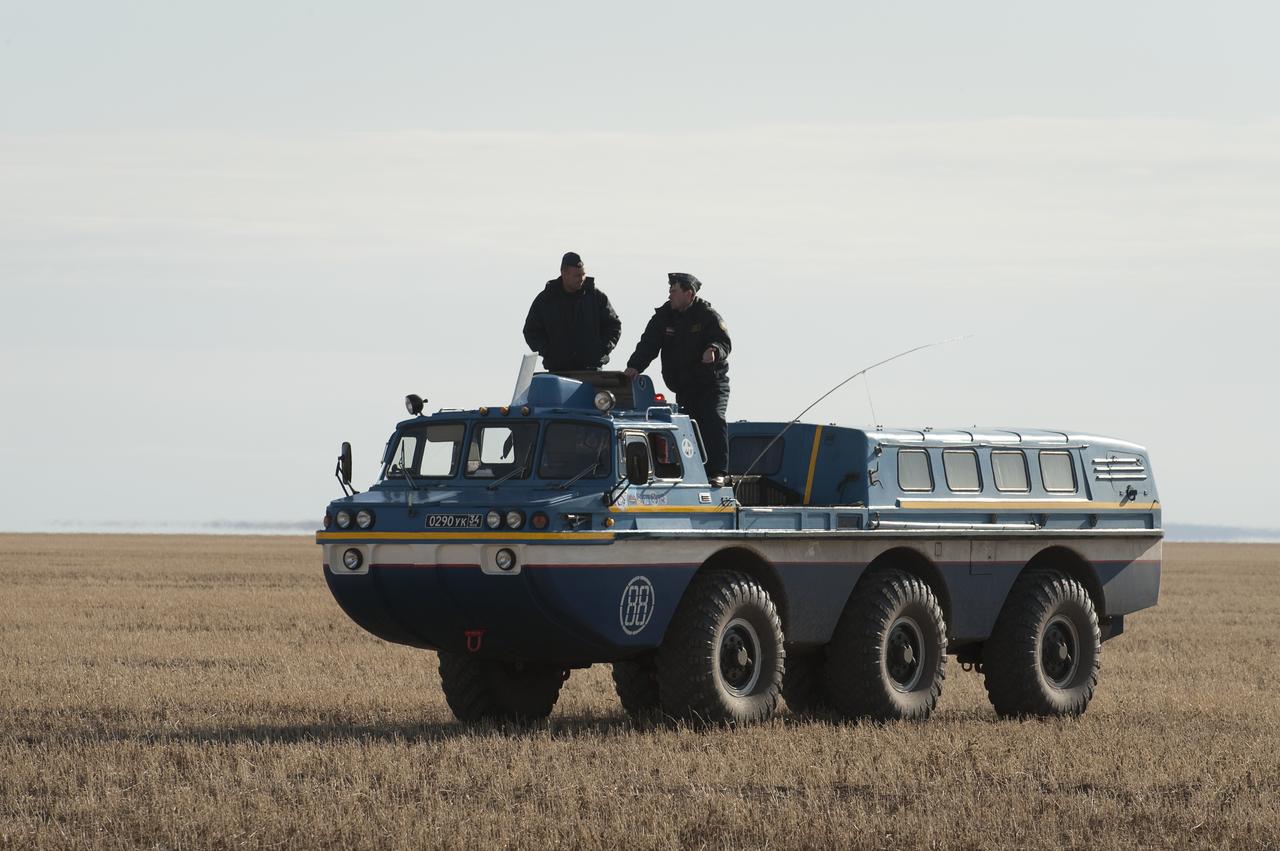 A Russian Search and Rescue team All Terrain Vehicle (ATV) brings Expedition 20 Flight Engineer Michael Barratt to his helicopter shortly after he and Expedition 20 Commander Gennady Padalka, and spaceflight participant Guy Laliberté landed their Soyuz TMA-14 capsule near the town of Arkalyk, Kazakhstan on Sunday, Oct. 11, 2009. Padalka and Barratt are returning from six months onboard the International Space Station, along with Laliberté who arrived at the station on Oct. 2 with Expedition 21 Flight Engineers Jeff Williams and Maxim Suraev aboard the Soyuz TMA-16 spacecraft. Photo Credit: (NASA/Bill Ingalls)