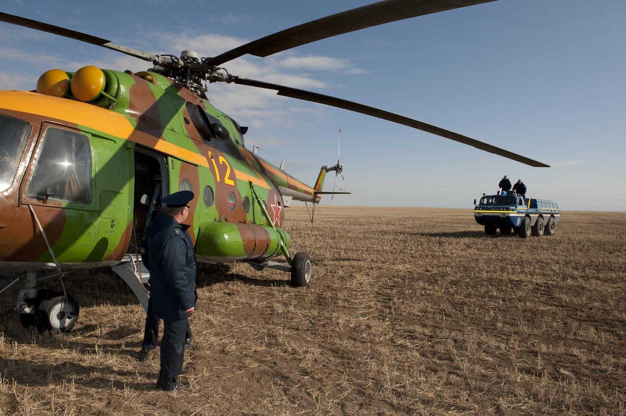 A Russian Search and Rescue team All Terrain Vehicle (ATV) brings Expedition 20 Flight Engineer Michael Barratt to his helicopter shortly after he and Expedition 20 Commander Gennady Padalka, and spaceflight participant Guy Laliberté landed their Soyuz TMA-14 capsule near the town of Arkalyk, Kazakhstan on Sunday, Oct. 11, 2009. Padalka and Barratt are returning from six months onboard the International Space Station, along with Laliberté who arrived at the station on Oct. 2 with Expedition 21 Flight Engineers Jeff Williams and Maxim Suraev aboard the Soyuz TMA-16 spacecraft. Photo Credit: (NASA/Bill Ingalls)