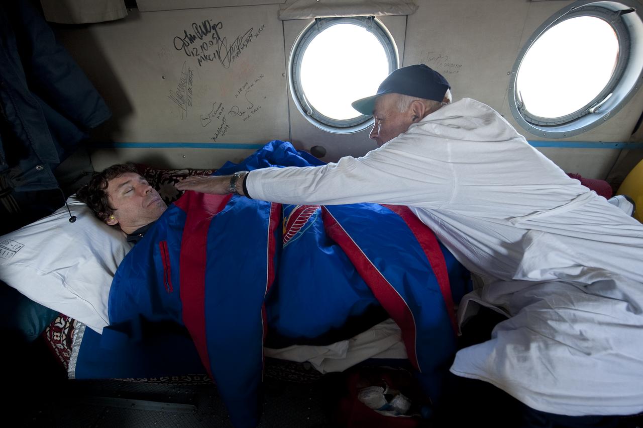 A Russian doctor monitors Expedition 20 Flight Engineer Michael Barratt onboard a helicopter heading to Kustanay, Kazakhstan shortly after Barratt, Expedition 20 Commander Gennady Padalka, and spaceflight participant Guy Laliberté landed their Soyuz TMA-14 capsule near the town of Arkalyk, Kazakhstan on Sunday, Oct. 11, 2009. Padalka and Barratt are returning from six months onboard the International Space Station, along with Laliberté who arrived at the station on Oct. 2 with Expedition 21 Flight Engineers Jeff Williams and Maxim Suraev aboard the Soyuz TMA-16 spacecraft.  Photo Credit: (NASA/Bill Ingalls)