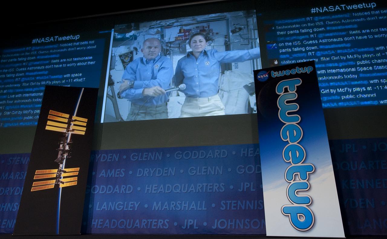 Expedition 20 Flight Engineers Jeff Williams, left, and Nicole Stott are seen during a live broadcast from the International Space Station (ISS) as they answer questions from NASA Twitter followers at NASA Headquarters in Washington, on what it is like to live and work in space, Wednesday, Oct. 21, 2009. Photo Credit: (NASA/Carla Cioffi)