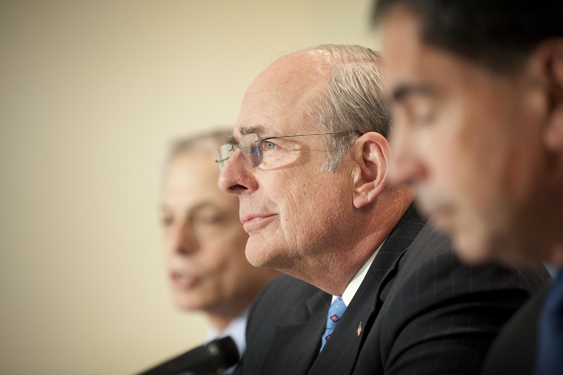 Norman Augustine sits with a panel for a press conference in 2009