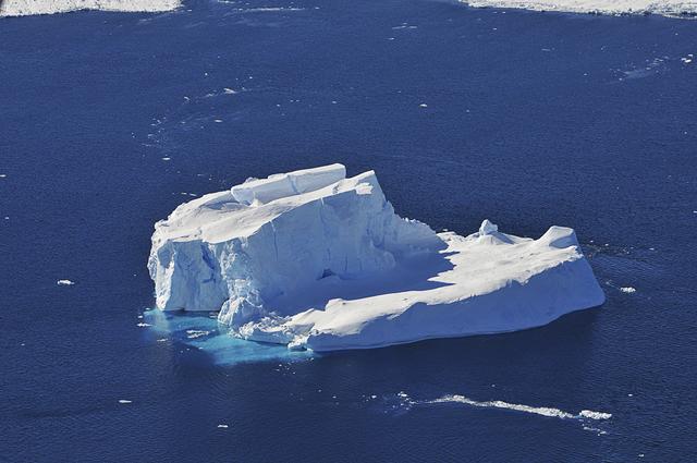 An iceberg is seen out the window of NASA's DC-8 research aircraft as it flies 2,000 feet above the Amundsen Sea in West Antarctica on Wednesday, Oct., 21, 2009. This was the fourth science flight of NASA’s Operation Ice Bridge airborne Earth science mission to study Antarctic ice sheets, sea ice, and ice shelves. Photo Credit: (NASA/Jane Peterson)