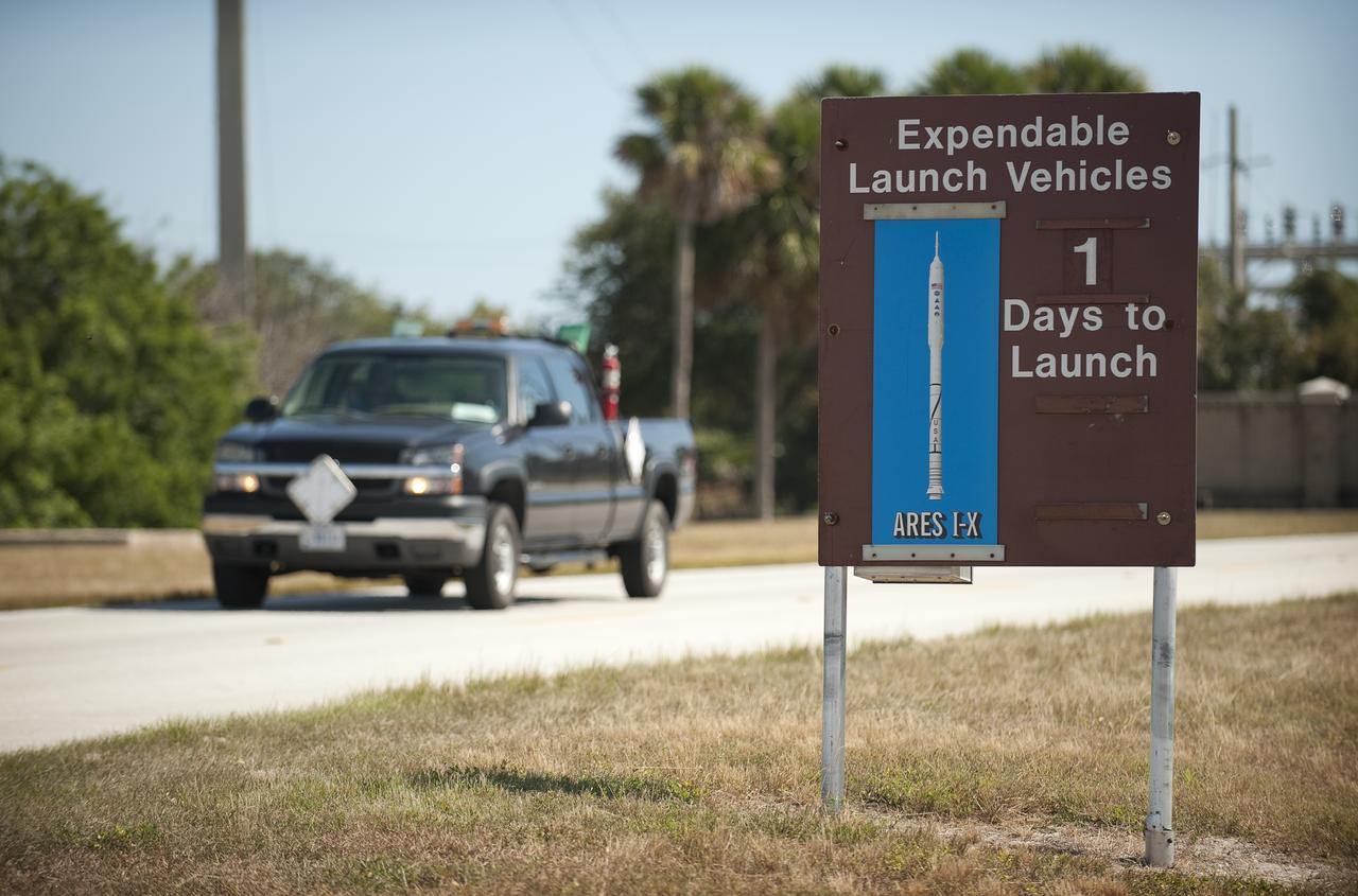 A launch countdown sign showing one day until launch of the NASA ARES I-X rocket is seen along the road between Cape Canaveral Air Force Base and the NASA Kennedy Space Center in Cape Canaveral, Florida on Monday, Oct. 26, 2009. The flight test of Ares I-X, scheduled for Tuesday, Oct. 27, 2009, will provide NASA with an early opportunity to test and prove flight characteristics, hardware, facilities and ground operations associated with the Ares I.   Photo Credit: (NASA/Bill Ingalls)
