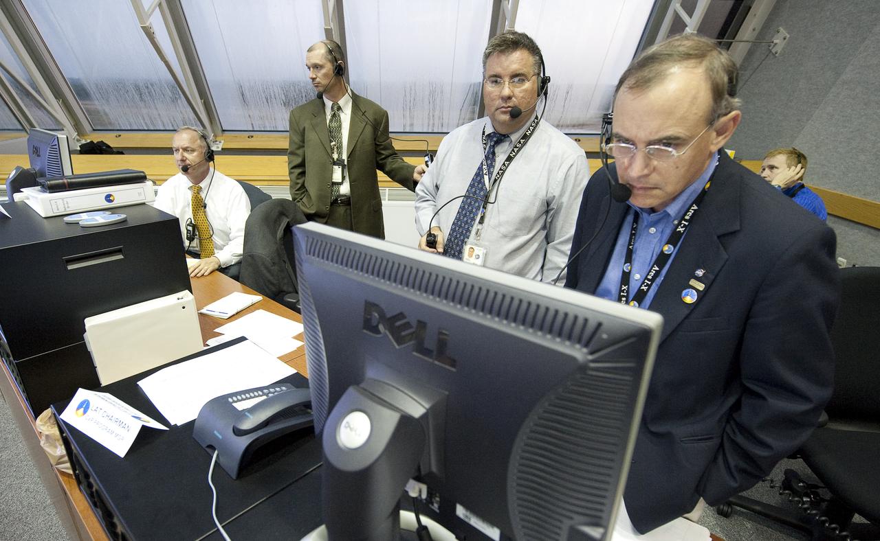 Mission managers, from left, NASA Ares I-X Assistant Launch Director Pete Nickolenko, Ground Operations Manager Philip "Pepper" Phillips, Ares I-X Launch Director Ed Mango, and Constellation Program manager Jeff Hanley review the latest weather radar from Firing Room One of the Launch Control Center (LCC) at the Kennedy Space Center during the launch countdown of the Ares I-X rocket in Cape Canaveral, Fla., Tuesday, Oct. 27, 2009.  The flight test of Ares I-X will provide NASA with an early opportunity to test and prove flight characteristics, hardware, facilities and ground operations associated with the Ares I.  Photo Credit: (NASA/Bill Ingalls)