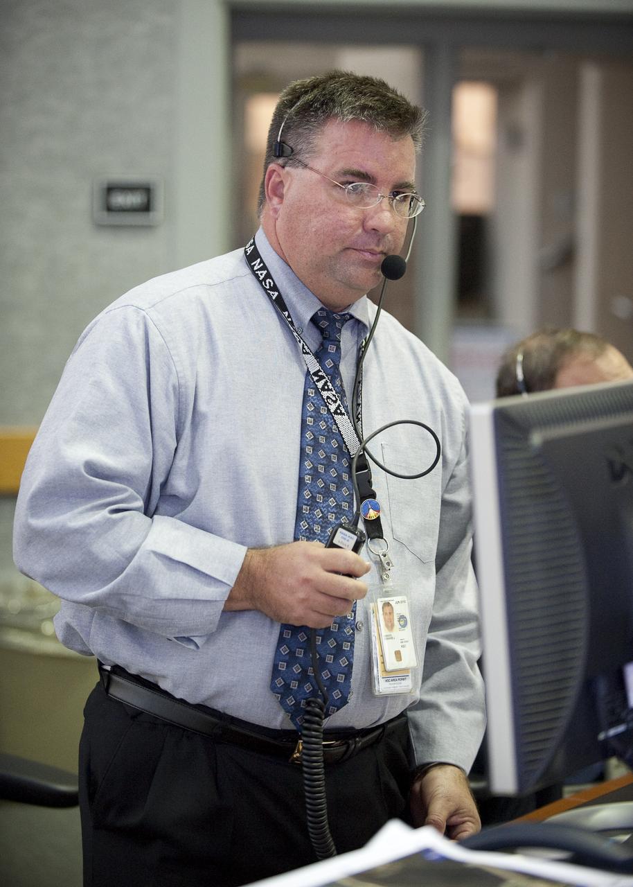 NASA Ares I-X Launch Director Ed Mango monitors the launch countdown from Firing Room One of the Launch Control Center (LCC) at the Kennedy Space Center during the planned launch of the Ares I-X rocket from pad 39b at the Kennedy Space Center in Cape Canaveral, Fla., Tuesday, Oct. 27, 2009.  The flight test of Ares I-X will provide NASA with an early opportunity to test and prove flight characteristics, hardware, facilities and ground operations associated with the Ares I.  Photo Credit: (NASA/Bill Ingalls)