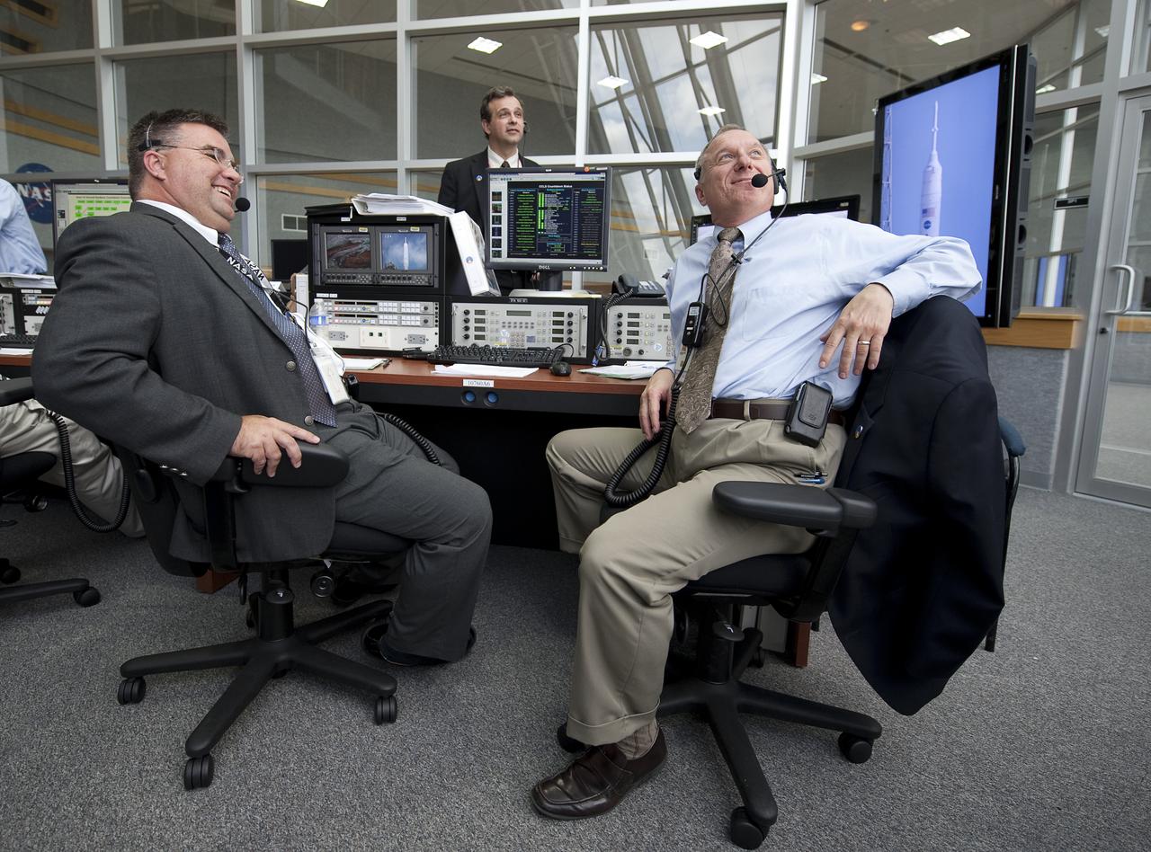NASA Ares I-X Launch Director Ed Mango, left, laughs as NASA Ares I-X Assistant Launch Director Pete Nickolenko looks out the window of Firing Room One of the Launch Control Center (LCC) at the Kennedy Space Center prior to the launch of the Ares I-X rocket from pad 39b at the Kennedy Space Center in Cape Canaveral, Fla., Wednesday, Oct. 28, 2009.  The flight test of Ares I-X will provide NASA with an early opportunity to test and prove flight characteristics, hardware, facilities and ground operations associated with the Ares I.  Photo Credit: (NASA/Bill Ingalls)
