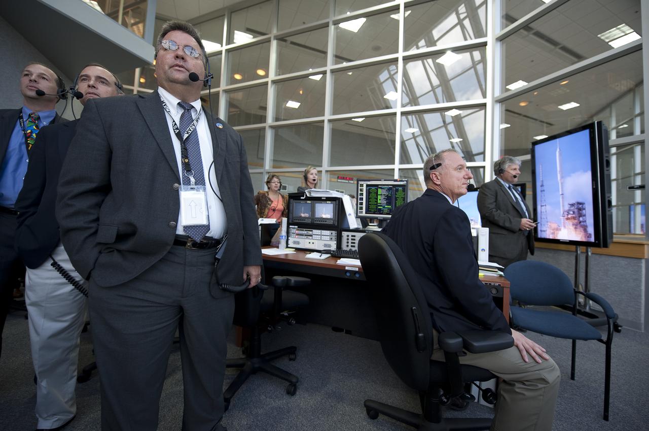 NASA Ares I-X Launch Director Ed Mango, 3rd from left, along with other mission managers watches the launch of the Ares I-X rocket from Firing Room One of the Launch Control Center (LCC) at the Kennedy Space Center in Cape Canaveral, Fla., Wednesday, Oct. 28, 2009.  The flight test of Ares I-X will provide NASA with an early opportunity to test and prove flight characteristics, hardware, facilities and ground operations associated with the Ares I.  Photo Credit: (NASA/Bill Ingalls)