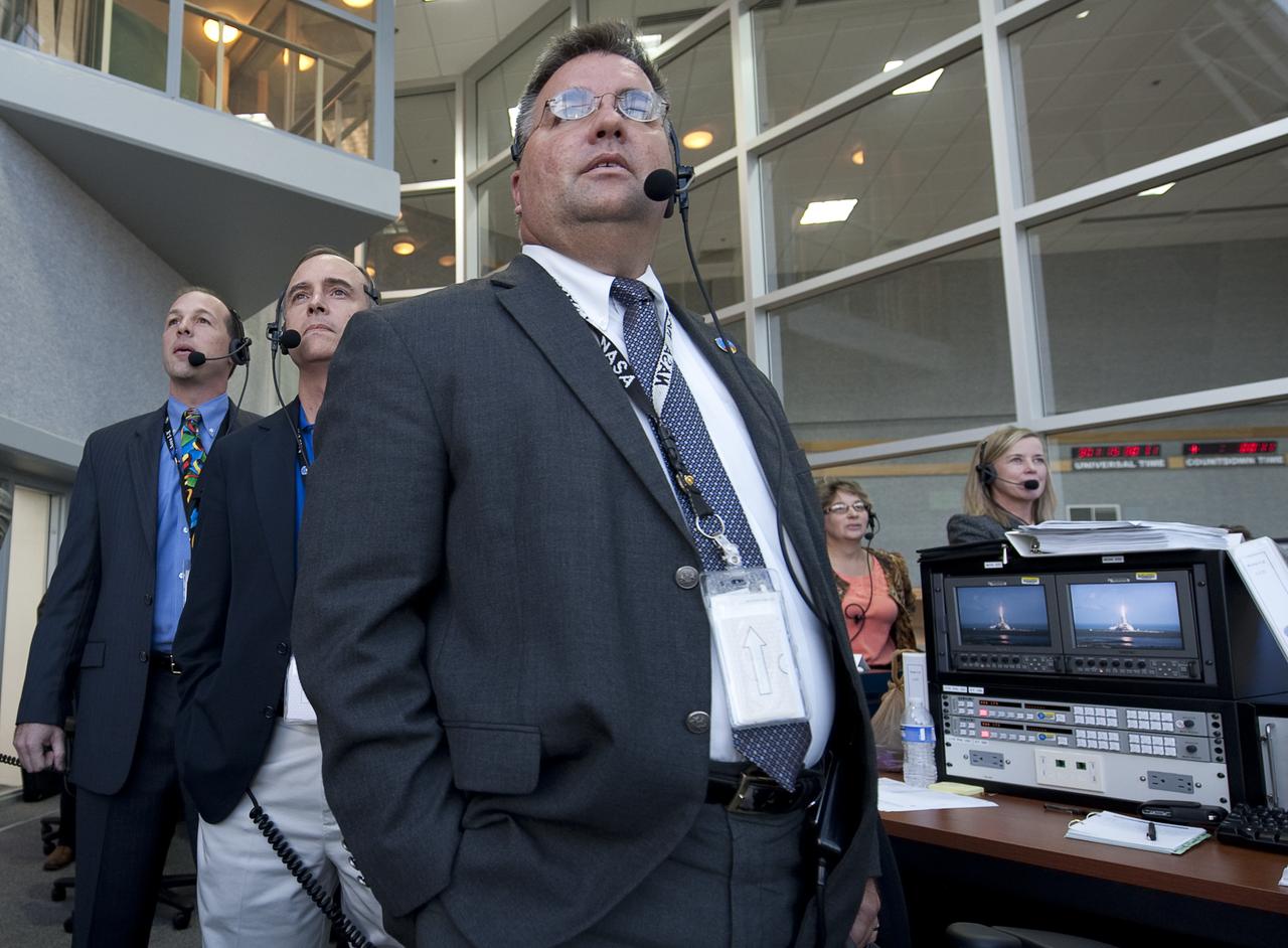 NASA Ares I-X Launch Director Ed Mango, 3rd from left, along with other mission managers watches the launch of the Ares I-X rocket from Firing Room One of the Launch Control Center (LCC) at the Kennedy Space Center in Cape Canaveral, Fla., Wednesday, Oct. 28, 2009.  The flight test of Ares I-X will provide NASA with an early opportunity to test and prove flight characteristics, hardware, facilities and ground operations associated with the Ares I.  Photo Credit: (NASA/Bill Ingalls)