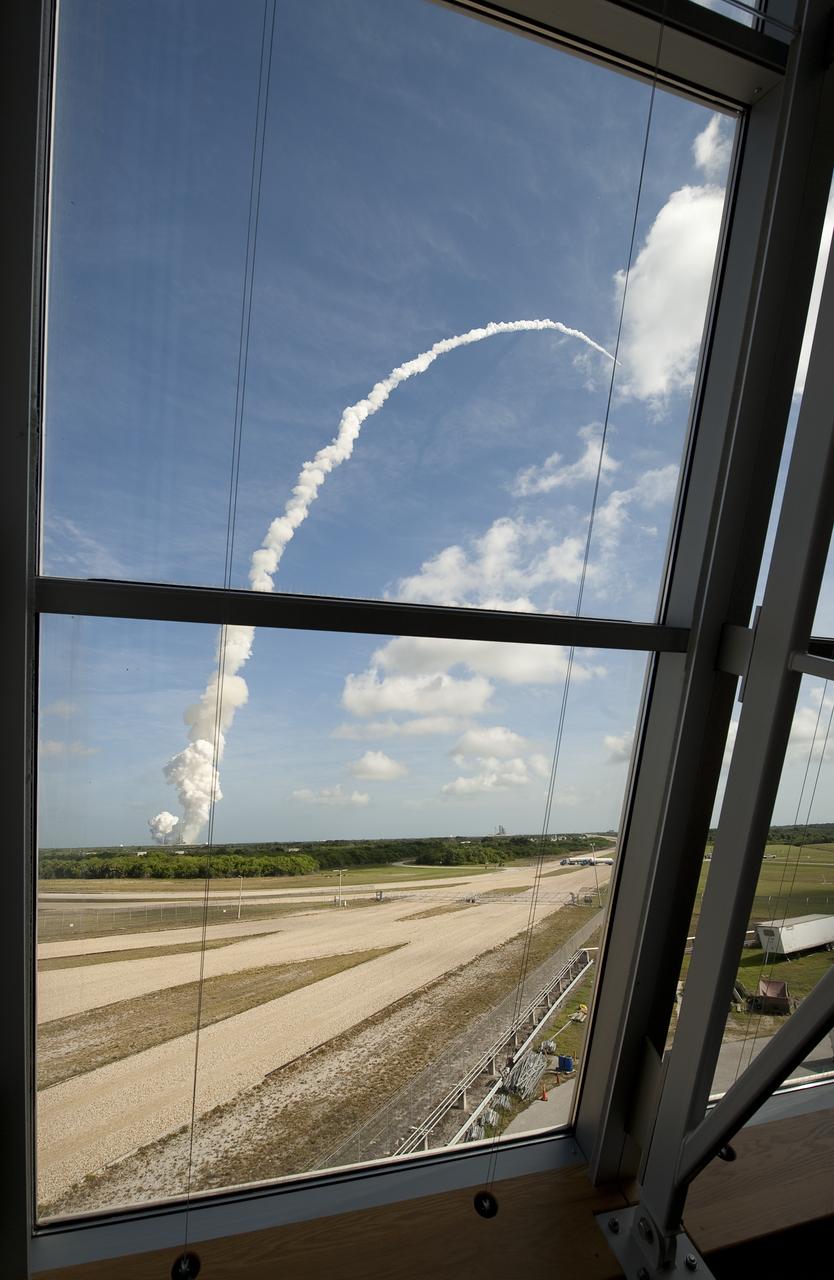 NASA's Ares I-X rocket is seen through the windows of Firing Room One of teh Launch Control Center (LCC) at the Kennedy Space Center as it launches from pad 39b in Cape Canaveral, Fla., Wednesday, Oct. 28, 2009.  The flight test will provide NASA with an early opportunity to test and prove flight characteristics, hardware, facilities and ground operations associated with the Ares I.  Photo Credit: (NASA/Bill Ingalls)