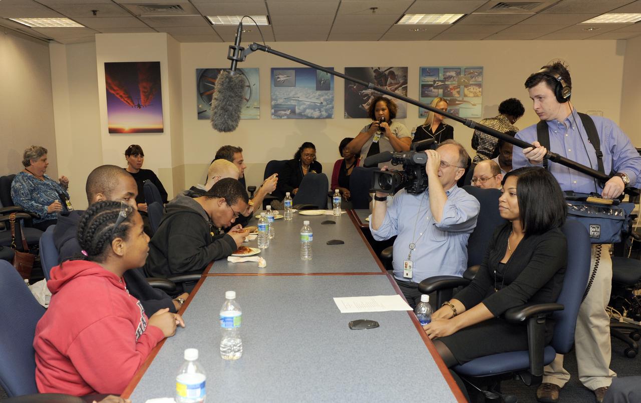Maryland School for the Blind student Andrea Washington, left, in red, is interviewed by NASA television during a visit to NASA Headquarters in Washington, Thursday, Oct. 29, 2009.  Seven students from the Maryland School for the Blind visited NASA and participated in activities to learn about NASA'smission, functions, and careers. Photo Credit: (NASA/Paul E. Alers)