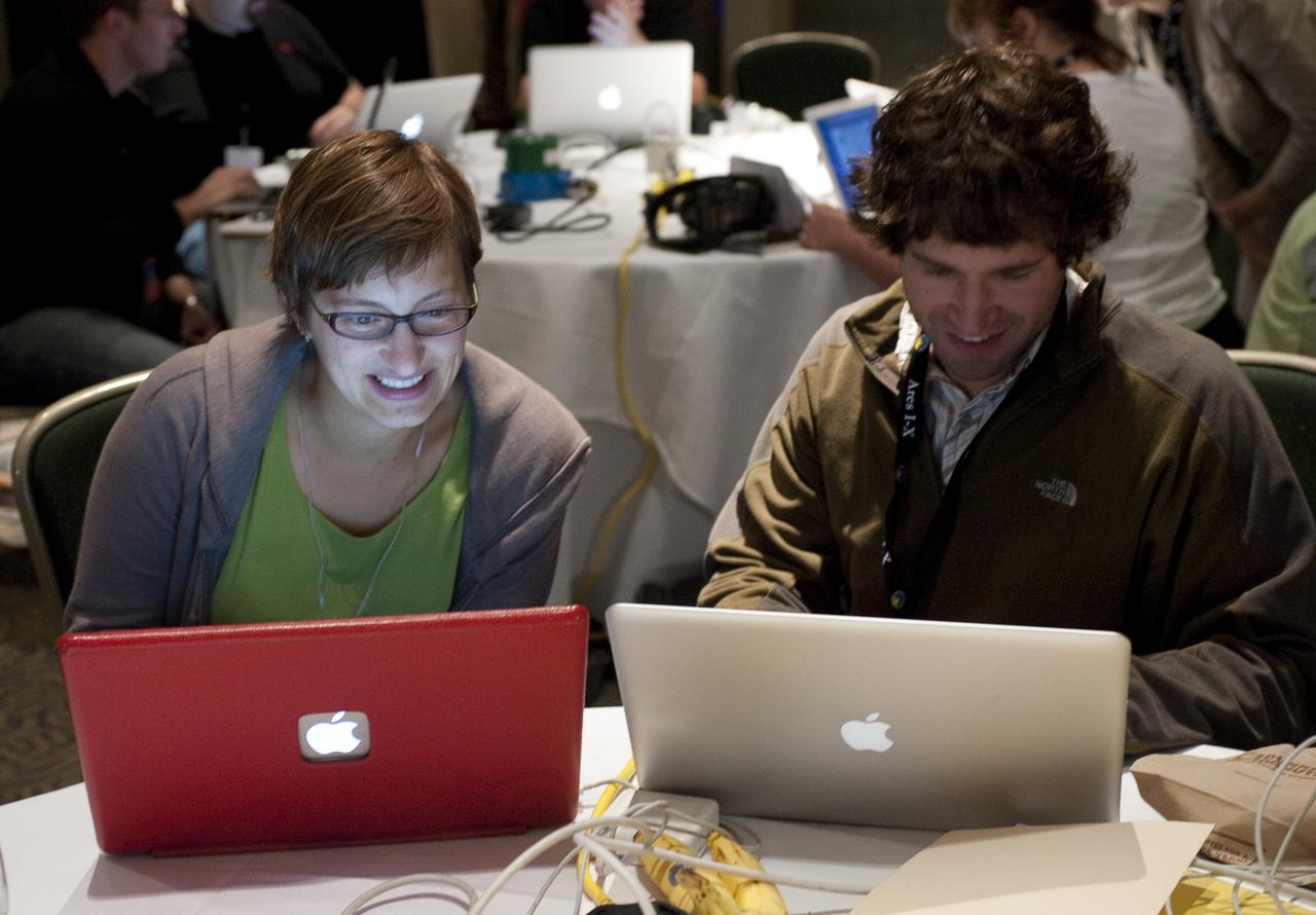 Twitter users Risa Wechster from Stanford University, left, and Daniel Holz from Los Alamos, both twitter for @cosmicvariance during a two-day NASA Tweetup event held at NASA's Kennedy Space Center in Cape Canaveral, Fla, Sunday, Nov. 15, 2009. NASA Twitter followers in attendance will have the opportunity to take a tour of NASA's Kennedy Space Center, view the STS-129 space shuttle launch and speak with shuttle technicians, engineers, astronauts and managers.  Photo Credit: (NASA/Carla Cioffi)