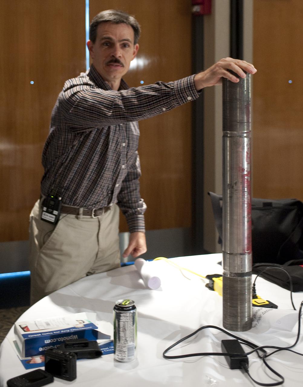 Ares I-X Deputy Mission Manager Jon Cowart shows a space shuttle solid rocket booster (SRB) separation bolt during a two-day NASA Tweetup event held at NASA's Kennedy Space Center in Cape Canaveral, Fla, Sunday, Nov. 15, 2009. NASA Twitter followers in attendance will have the opportunity to take a tour of NASA's Kennedy Space Center, view the STS-129 space shuttle launch and speak with shuttle technicians, engineers, astronauts and managers.  Photo Credit: (NASA/Carla Cioffi)