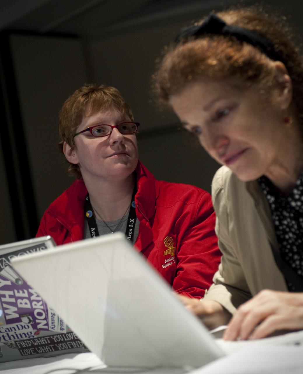 Twitter user Laura Burns, left, who goes by the twitter name @moonrangerlaura, listens to a guest speaker, while Ann Marie Cunningham who goes by the twitter name @talkingscience.org, uses her laptop during a two-day NASA Tweetup event held at NASA's Kennedy Space Center in Cape Canaveral, Fla, Sunday, Nov. 15, 2009. NASA Twitter followers in attendance will have the opportunity to take a tour of NASA's Kennedy Space Center, view the space shuttle launch and speak with shuttle technicians, engineers, astronauts and managers. Photo Credit: (NASA/Carla Cioffi)¬†