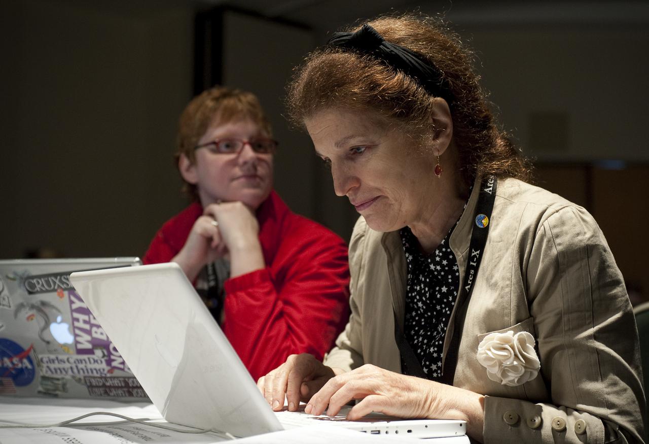 Twitter user Ann Marie Cunningham who goes by the twitter name @talkingscience.org, right, uses her laptop, while Laura Burns, who goes by the twitter name @moonrangerlaura, listens to a guest speaker during a two-day NASA Tweetup event held at NASA's Kennedy Space Center in Cape Canaveral, Fla, Sunday, Nov. 15, 2009. NASA Twitter followers in attendance will have the opportunity to take a tour of NASA's Kennedy Space Center, view the space shuttle launch and speak with shuttle technicians, engineers, astronauts and managers. Photo Credit: (NASA/Carla Cioffi)¬†