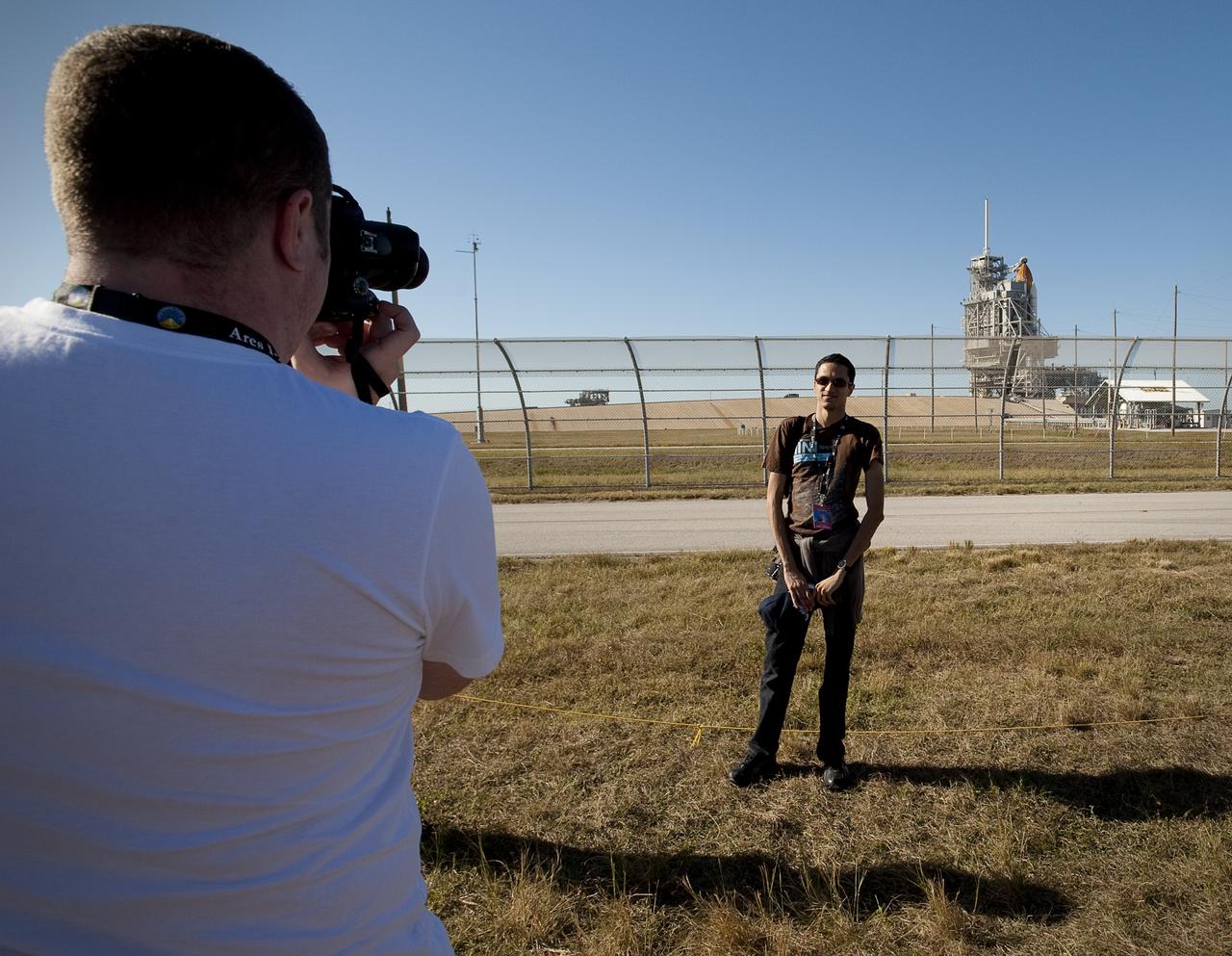 A NASA "Tweep" has his picture taken in front of space shuttle Atlantis at launch pad 39A during a tour of Kennedy Space Center in Cape Canaveral, Fla, Sunday, Nov. 15, 2009. Space shuttle Atlantis is set to launch on Monday, Nov. 16, 2009 and dock with the International Space Station (ISS) two days later.  Photo Credit: (NASA/Carla Cioffi)