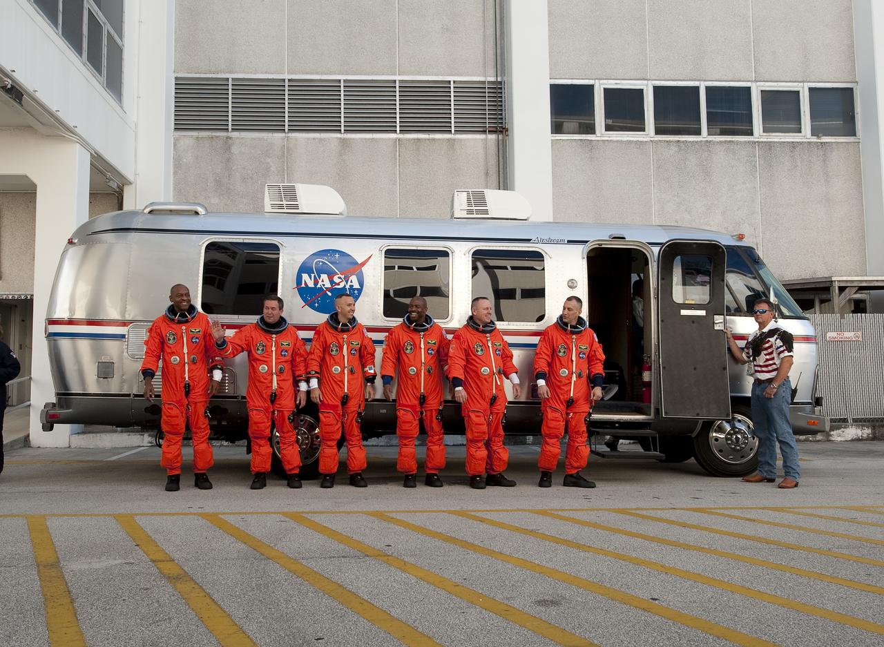 STS-129 crew members, from left, Robert Satcher, Mike Foreman, Randy Bresnik, Leland Melvin, Pilot Barry Wilmore, and Mission Commander Charlie Hobaugh stop and pose for a photograph before getting into the astrovan and heading to launch pad 39a at the NASA Kennedy Space Center in Cape Canaveral, Fl on Monday, Nov. 16, 2009.  Photo Credit: (NASA/Bill Ingalls)