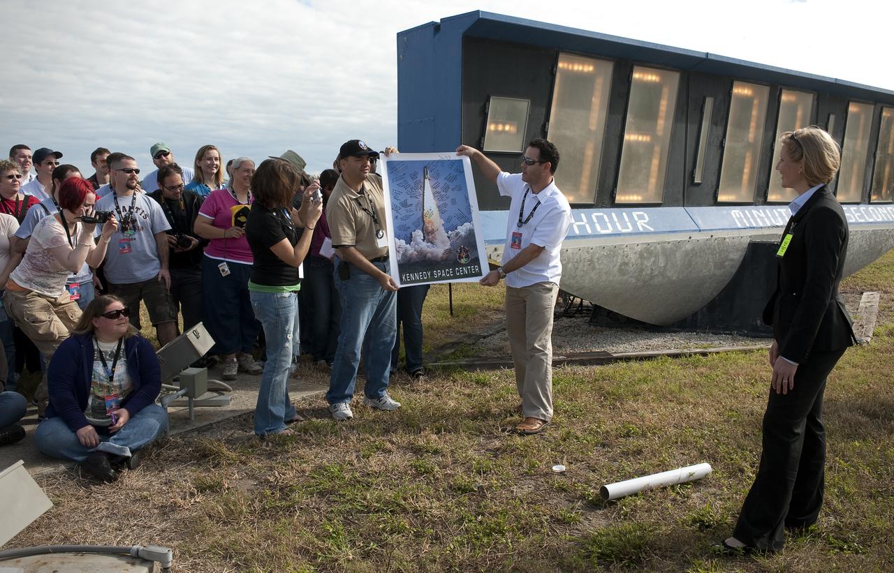 NASA Twitter followers attending a two-day NASA Tweetup presented NASA Public Affairs Officers with a signed poster from Kennedy Space Center expressing their appreciation for hosting this unique event, Monday, Nov. 16, 2009 in Cape Canaveral, Fla.  Photo Credit: (NASA/Carla Cioffi)
