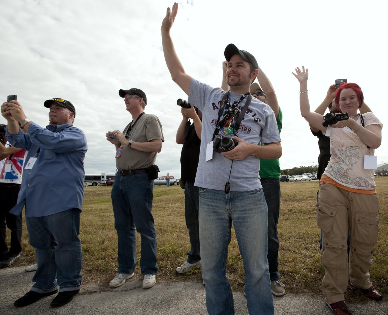 NASA Twitter followers wave to the Astro van as it passes by en route to launch pad 39A with the crew of STS-129, Monday, Nov. 16, 2009 at Kennedy Space Center in Cape Canaveral, Fla.  The Twitter users were part of a unique two-day NASA Tweetup at Kennedy Space Center.  Photo Credit:  (NASA/Carla Cioffi)
