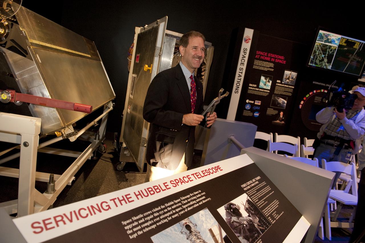 STS-125 astronaut John Grunsfeld stands behind a display of Hubble memorabilia during a press briefing at the new "Moving Beyond Earth," a new exhibition at the National Air and Space Museum in Washingon, Wednesday, Nov. 18, 2009. Moving Beyond Earth is an immersive exhibition that places visitors “in orbit” in the shuttle and space-station era to explore recent human spaceflight and future possibilities. Photo Credit: (NASA/Paul E. Alers)