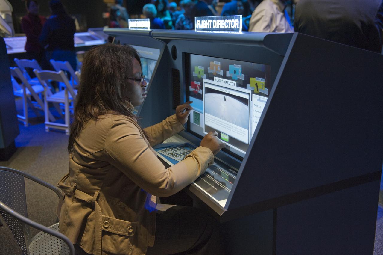 An unidentified member of the media tries out an interactive display during a press briefing at the new "Moving Beyond Earth," exhibition at the National Air and Space Museum in Washingon, Wednesday, Nov. 18, 2009. Moving Beyond Earth is an immersive exhibition that places visitors ‚Äúin orbit‚Äù in the shuttle and space-station era to explore recent human spaceflight and future possibilities.  Photo Credit: (NASA/Paul E. Alers)