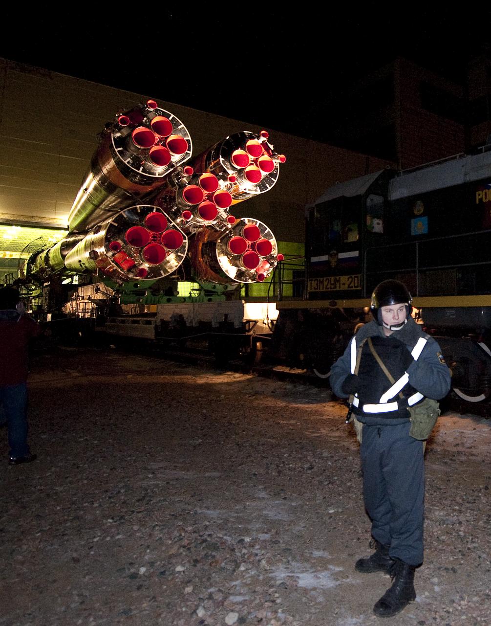 A security guard keeps watch as the Soyuz TMA-17 spacecraft is rolled out by train to the launch pad at the Baikonur Cosmodrome, Kazakhstan, Friday, Dec. 18, 2009.  The launch of the Soyuz spacecraft with Expedition 22 NASA Flight Engineer Timothy J. Creamer of the U.S., Soyuz Commander Oleg Kotov of Russia and Flight Engineer Soichi Noguchi of Japan, is scheduled for Monday, Dec., 21, 2009 at 3:52a.m. Kazakhstan time.  Photo Credit (NASA/Bill Ingalls)