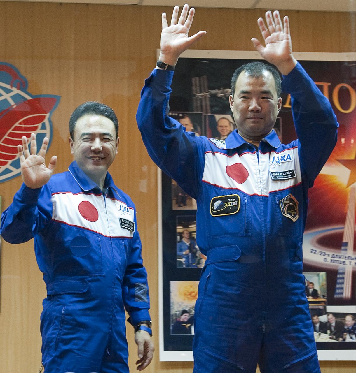 Expedition 22 Flight Engineer Soichi Noguchi of Japan, right, and backup crew member Satoshi Furakawa wave farewell to reporters and family after a press conference held at the Cosmonaut Hotel in Baikonur, Kazakhstan, Saturday, Dec., 19, 2009. The launch of the Soyuz spacecraft with Expedition 22 NASA Flight Engineer Timothy J. Creamer of the U.S., Soyuz Commander Oleg Kotov of Russia and Flight Engineer Soichi Noguchi of Japan, is scheduled for Monday, Dec., 21, 2009 at 3:52a.m. Kazakhstan time.  Photo Credit (NASA/Bill Ingalls)