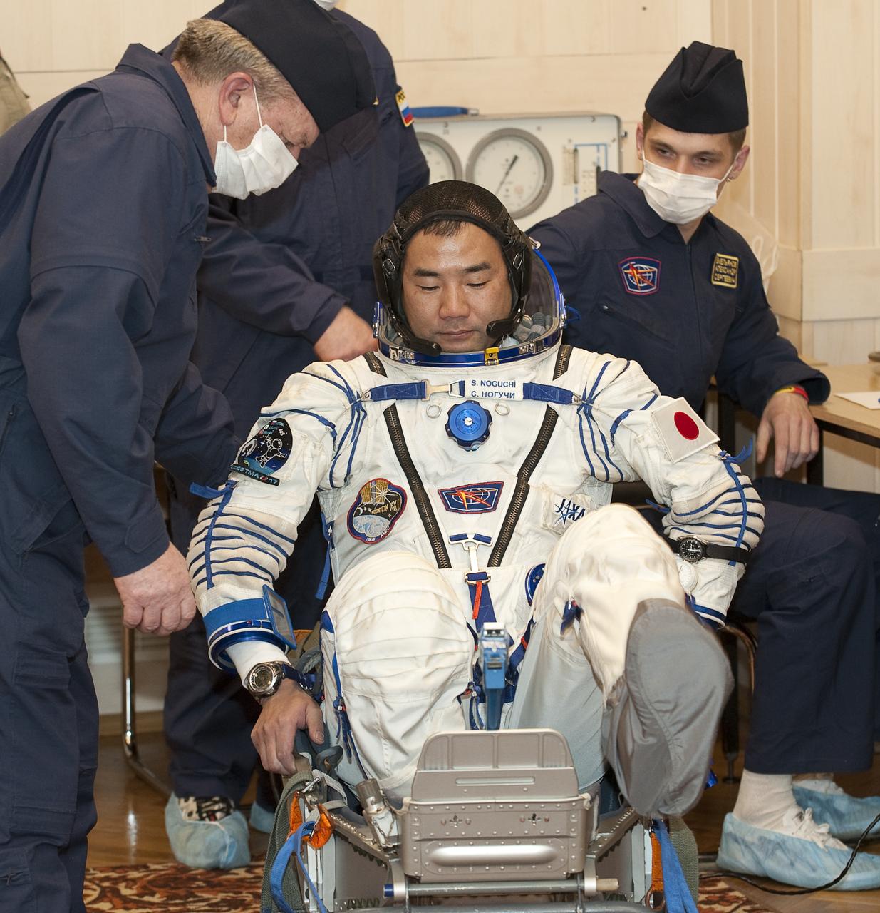Expedition 22 Flight Engineer Soichi Noguchi of Japan prepares to have his Russian Sokol suit pressure checked at the Baikonur Cosmodrome in Baikonur, Kazakhstan, Sunday, Dec. 20, 2009. Soichi and fellow Expedition 22 crew members NASA Flight Engineer Timothy J. Creamer of the U.S., Soyuz Commander Oleg Kotov of Russia launched in their Soyuz TMA-17 rocket from the Baikonur Cosmodrome in Kazakhstan on Monday, Dec. 21, 2009. (Photo Credit: NASA/Bill Ingalls)
