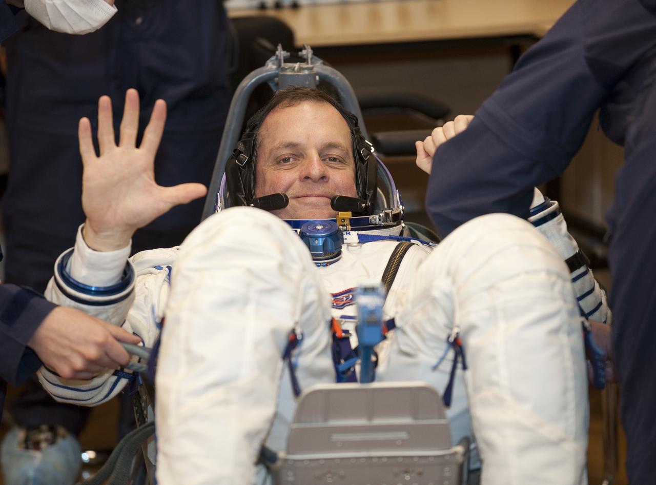 Expedition 22 NASA Flight Engineer Timothy J. Creamer of the U.S. waves after having his Russian Sokol suit pressure checked at the Baikonur Cosmodrome in Baikonur, Kazakhstan, Monday, Dec. 21, 2009. Creamer and fellow Expedition 22 crew members, Soyuz Commander Oleg Kotov of Russia, and Flight Engineer Soichi Noguchi of Japan launched in their Soyuz TMA-17 rocket from the Baikonur Cosmodrome in Kazakhstan on Monday, Dec. 21, 2009. (Photo Credit: NASA/Bill Ingalls)