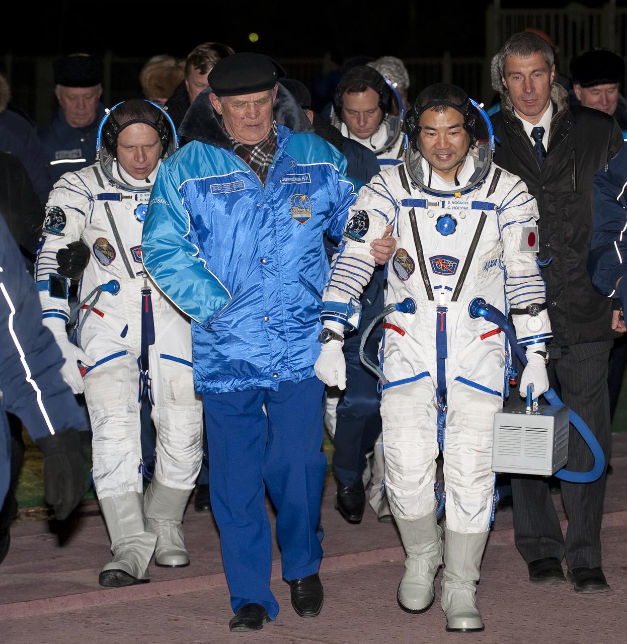 Expedition 22  Soyuz Commander Oleg Kotov of Russia, left, NASA Flight Engineer Timothy J. Creamer of the U.S., back center, and Flight Engineer Soichi Noguchi of Japan are walked from their bus to the soyuz rocket at the launch pad at the Baikonur Cosmodrome in Baikonur, Kazakhstan, Monday, Dec. 21, 2009. Kotov, Creamer and Noguchi launched in their Soyuz TMA-17 rocket from the Baikonur Cosmodrome in Kazakhstan on Monday, Dec. 21, 2009. (Photo Credit: NASA/Bill Ingalls)