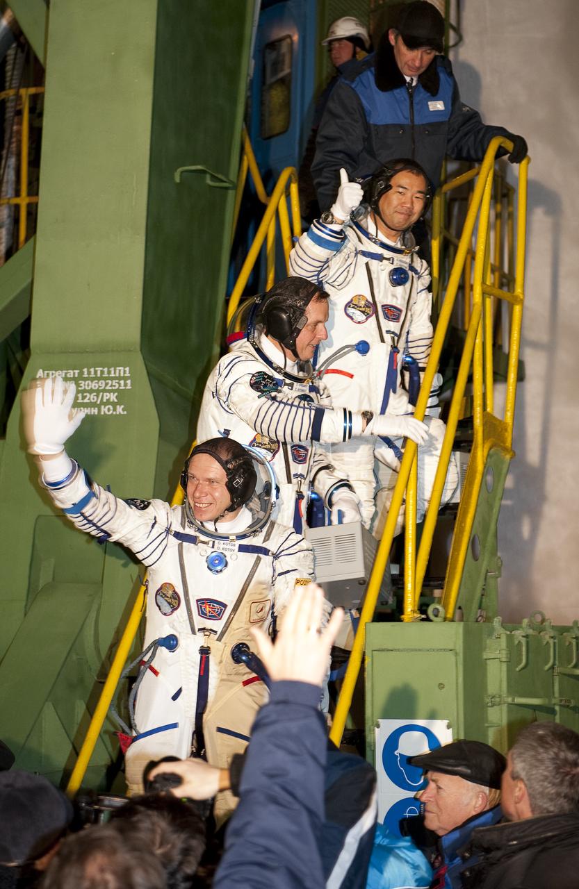 Expedition 22  Soyuz Commander Oleg Kotov of Russia, bottom, NASA Flight Engineer Timothy J. Creamer of the U.S., center, and Flight Engineer Soichi Noguchi of Japan wave farewell from the bottom of the soyuz rocket at the Baikonur Cosmodrome in Baikonur, Kazakhstan, Monday, Dec. 21, 2009. Kotov, Creamer and Noguchi launched in their Soyuz TMA-17 rocket from the Baikonur Cosmodrome in Kazakhstan on Monday, Dec. 21, 2009. (Photo Credit: NASA/Bill Ingalls)