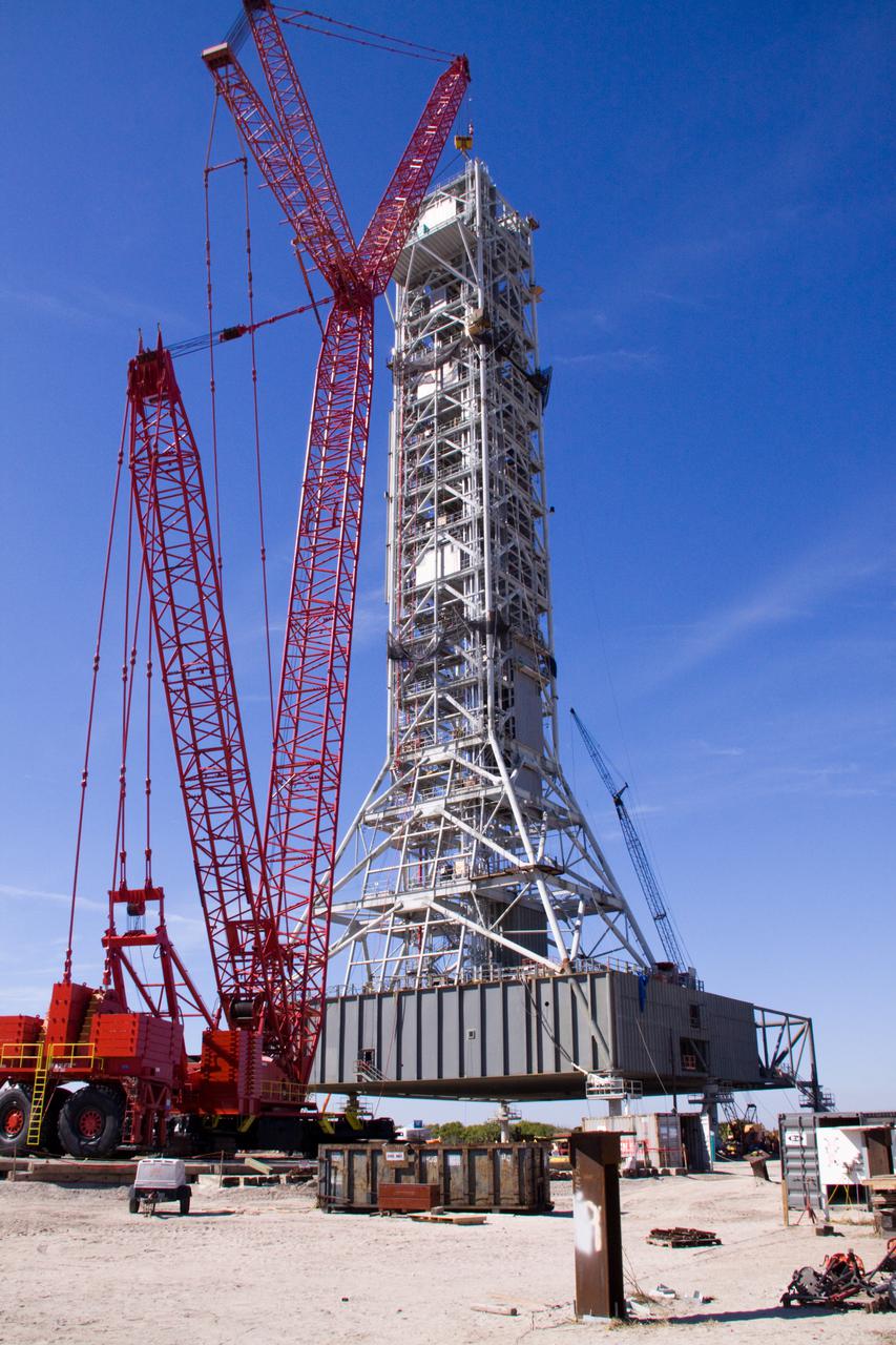 CAPE CANAVERAL, Fla. – At NASA's Kennedy Space Center in Florida, construction of the tower on the Constellation Program's new mobile launcher, or ML, progresses with placement of the ninth tower segment on the growing structure.  When completed, the tower will be approximately 345 feet tall and have multiple platforms for personnel access. Its base is being made lighter than space shuttle mobile launcher platforms so the crawler-transporter can pick up the heavier load of the tower and a taller rocket.  For information on the Constellation Program, visit http:__www.nasa.gov_constellation. Photo credit: NASA_Jack Pfaller
