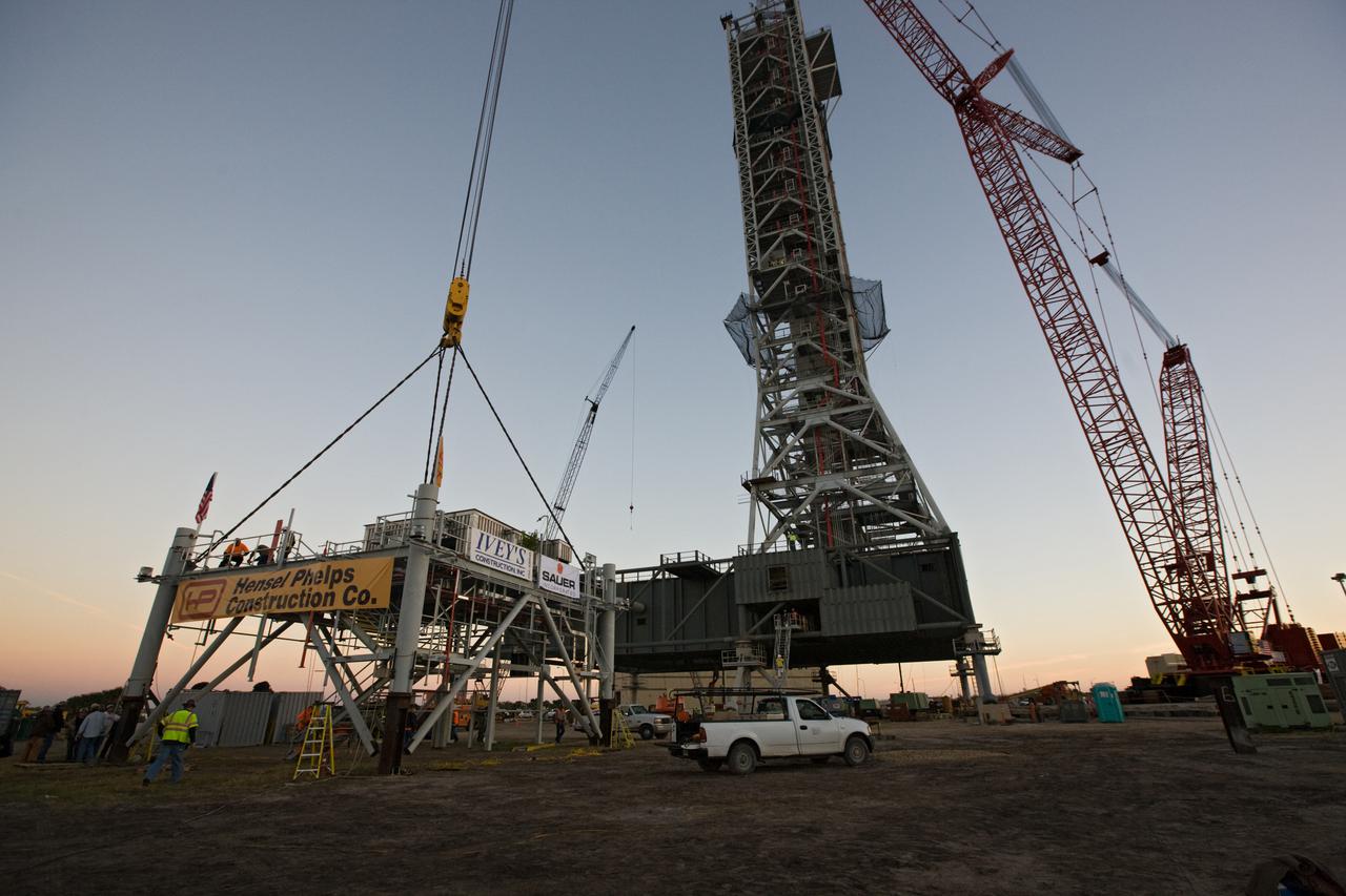CAPE CANAVERAL, Fla. – At NASA’s Kennedy Space Center in Florida, a large crane is attached to the tenth and final tower segment of the new mobile launcher, or ML, being constructed to support the Constellation Program. When completed, the tower will be approximately 345 feet tall and have multiple platforms for personnel access. Its base is being made lighter than space shuttle mobile launcher platforms so the crawler-transporter can pick up the heavier load of the tower and a taller rocket.  For information on the Constellation Program, visit http:__www.nasa.gov_constellation. Photo credit: NASA_Amanda Diller