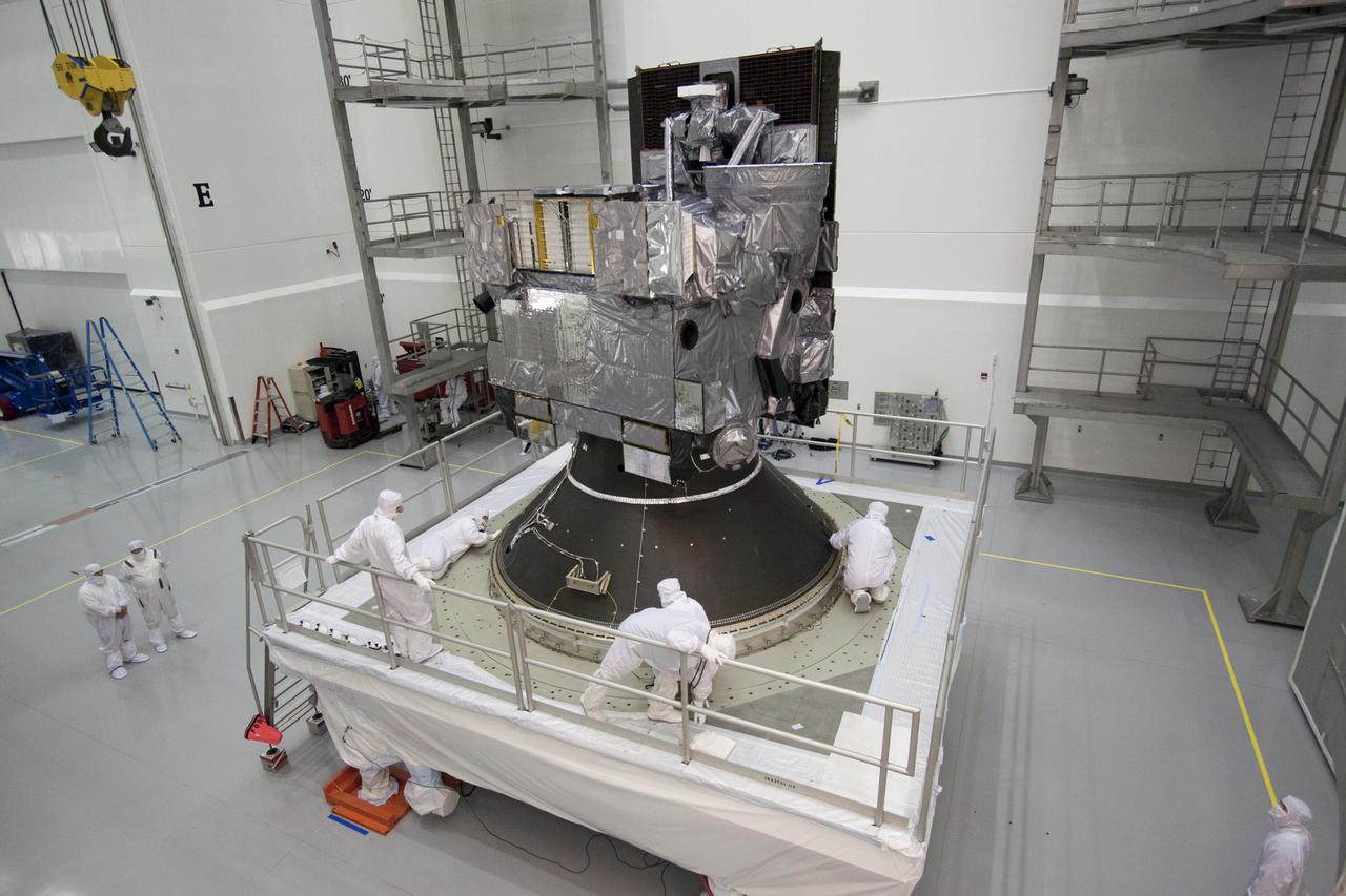CAPE CANAVERAL, Fla. – At the Astrotech Space Operations facility in Titusville, Fla., preparations are under way to enclose NASA's GOES-P meteorological satellite in the Delta IV payload fairing. The fairing is a molded clamshell covering that fits flush with the outside surface of the rocket and forms an aerodynamic nose cone, protecting the spacecraft during launch and ascent. GOES-P, the latest Geostationary Operational Environmental Satellite, was developed by NASA for the National Oceanic and Atmospheric Administration, or NOAA. GOES-P is designed to watch for storm development and observed current weather conditions on Earth. Launch of GOES-P is targeted for March 1 from Launch Complex 37 aboard a United Launch Alliance Delta IV rocket. For information on GOES-P, visit http:__www.nasa.gov_mission_pages_GOES-P_main_index.html. Photo credit: NASA_Jack Pfaller