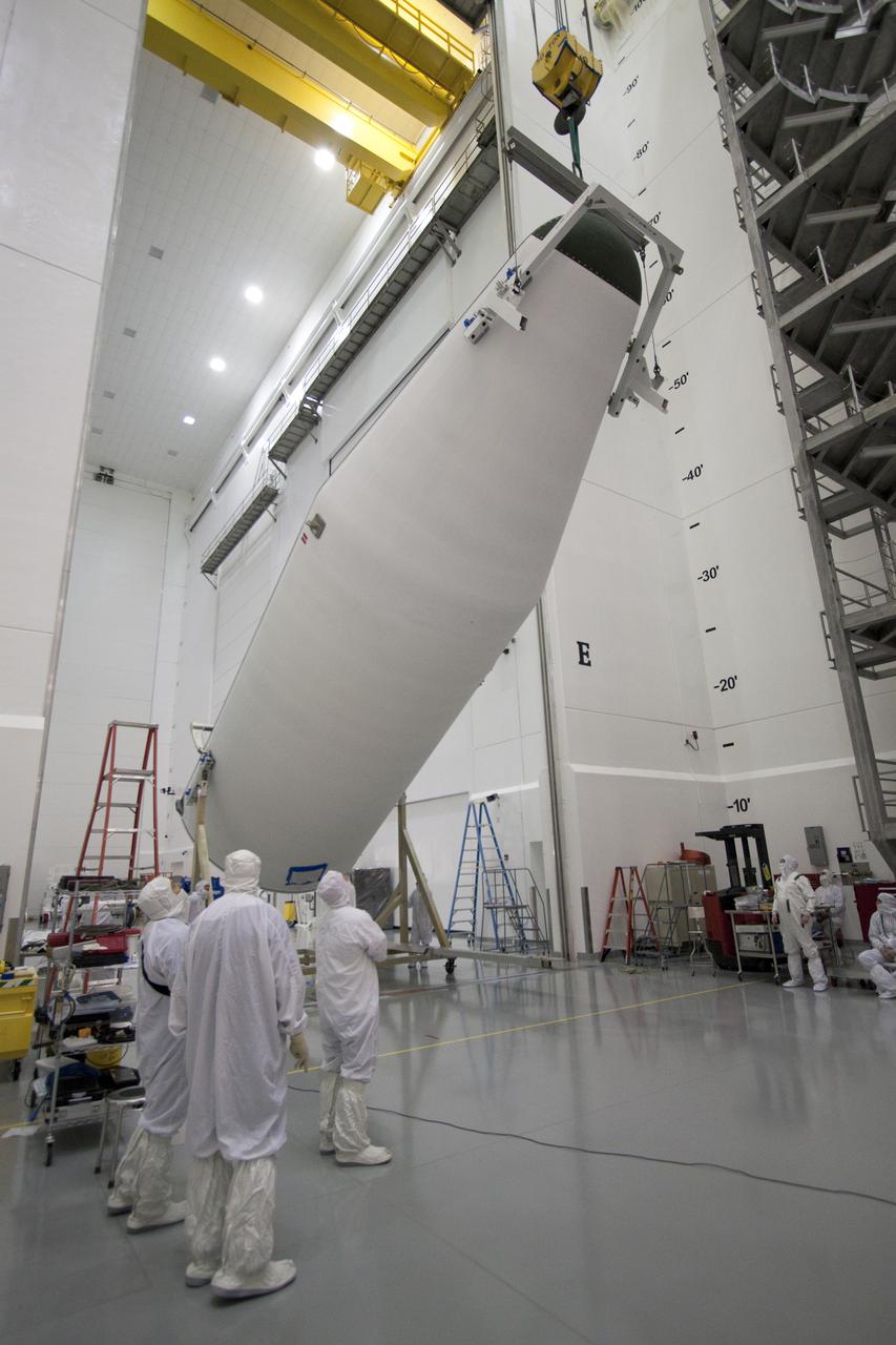 CAPE CANAVERAL, Fla. – At the Astrotech Space Operations facility in Titusville, Fla., the second half of the Delta IV payload fairing that will enclose NASA's GOES-P meteorological satellite is raised into a vertical position. The fairing is a molded clamshell covering that fits flush with the outside surface of the rocket and forms an aerodynamic nose cone, protecting the spacecraft during launch and ascent. GOES-P, the latest Geostationary Operational Environmental Satellite, was developed by NASA for the National Oceanic and Atmospheric Administration, or NOAA. GOES-P is designed to watch for storm development and observed current weather conditions on Earth. Launch of GOES-P is targeted for March 1 from Launch Complex 37 aboard a United Launch Alliance Delta IV rocket. For information on GOES-P, visit http:__www.nasa.gov_mission_pages_GOES-P_main_index.html. Photo credit: NASA_Jack Pfaller