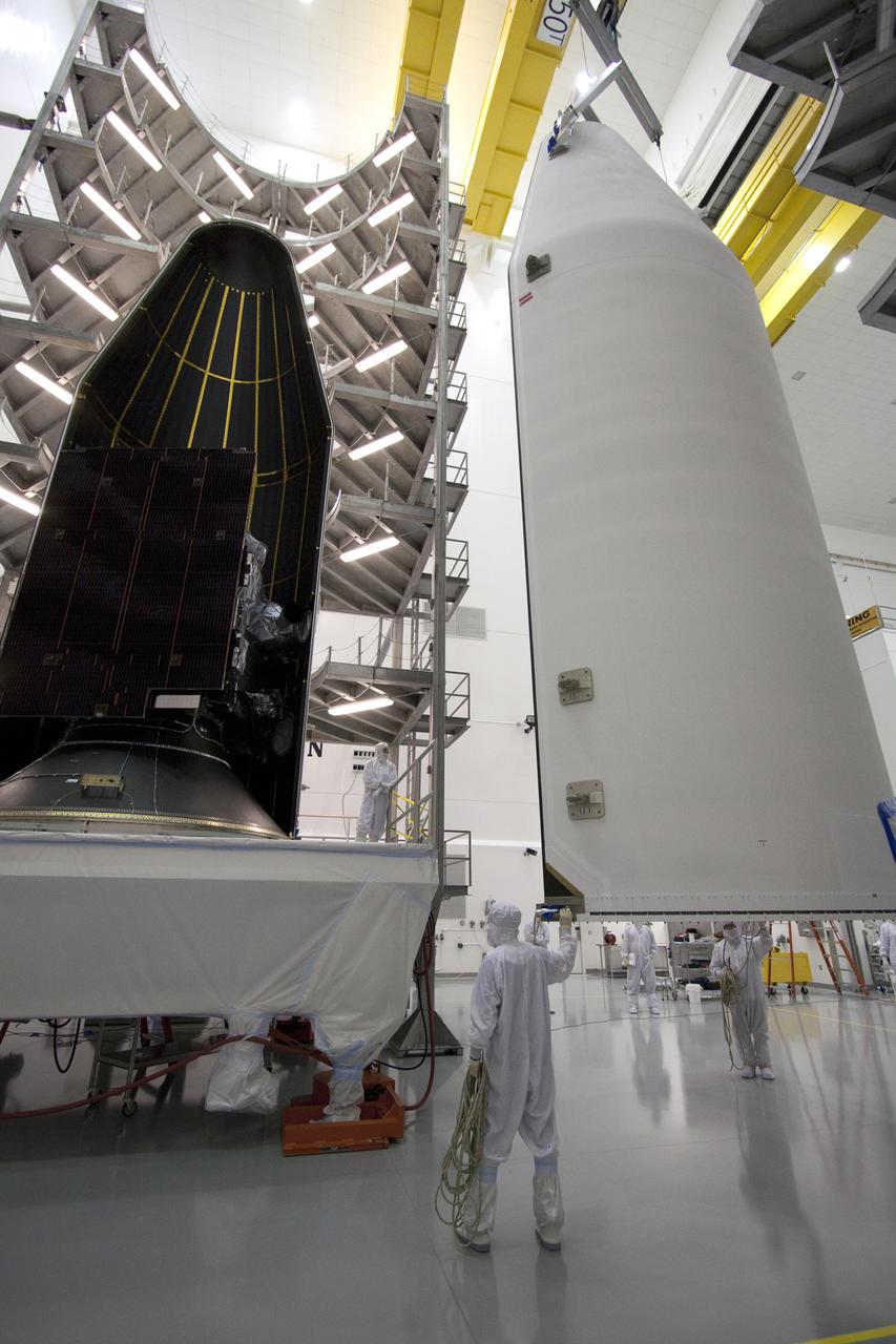 CAPE CANAVERAL, Fla. – At the Astrotech Space Operations facility in Titusville, Fla., the second half of the Delta IV payload fairing that will enclose NASA's GOES-P meteorological satellite is lifted toward the spacecraft. The fairing is a molded clamshell covering that fits flush with the outside surface of the rocket and forms an aerodynamic nose cone, protecting the spacecraft during launch and ascent. GOES-P, the latest Geostationary Operational Environmental Satellite, was developed by NASA for the National Oceanic and Atmospheric Administration, or NOAA. GOES-P is designed to watch for storm development and observed current weather conditions on Earth. Launch of GOES-P is targeted for March 1 from Launch Complex 37 aboard a United Launch Alliance Delta IV rocket. For information on GOES-P, visit http:__www.nasa.gov_mission_pages_GOES-P_main_index.html. Photo credit: NASA_Jack Pfaller