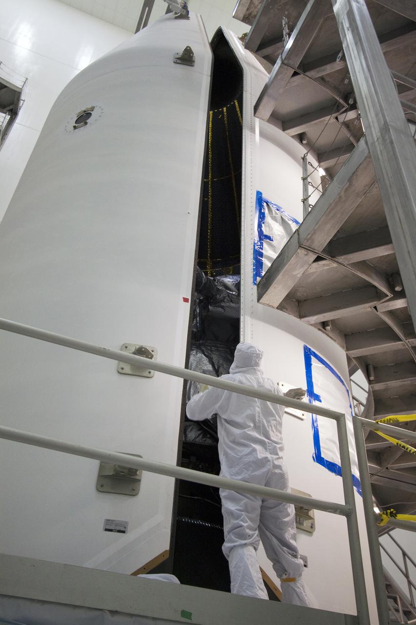 CAPE CANAVERAL, Fla. – At the Astrotech Space Operations facility in Titusville, Fla., spacecraft technicians close the second half of the Delta IV payload fairing around NASA's GOES-P meteorological satellite. The fairing is a molded clamshell covering that fits flush with the outside surface of the rocket and forms an aerodynamic nose cone, protecting the spacecraft during launch and ascent. GOES-P, the latest Geostationary Operational Environmental Satellite, was developed by NASA for the National Oceanic and Atmospheric Administration, or NOAA. GOES-P is designed to watch for storm development and observed current weather conditions on Earth. Launch of GOES-P is targeted for March 1 from Launch Complex 37 aboard a United Launch Alliance Delta IV rocket. For information on GOES-P, visit http:__www.nasa.gov_mission_pages_GOES-P_main_index.html. Photo credit: NASA_Jack Pfaller
