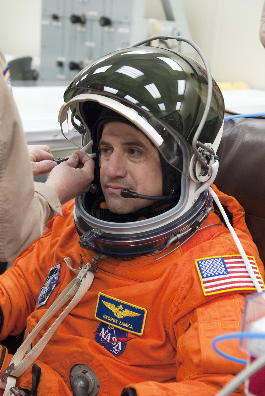 CAPE CANAVERAL, Fla. - In the Operations and Checkout Building at NASA's Kennedy Space Center in Florida, STS-130 Commander George Zamka has help checking the connections with his launch-and-entry suit's helmet before heading to the Astrovan for the ride to Launch Pad 39A.  This is the second launch attempt for space shuttle Endeavour's STS-130 crew.  The first attempt on Feb. 7 was scrubbed due to unfavorable weather. The primary payload for the STS-130 mission to the International Space Station is the Tranquility node, a pressurized module that will provide additional room for crew members and many of the station's life support and environmental control systems. Attached to one end of Tranquility is a cupola, a unique work area with six windows on its sides and one on top.  The cupola resembles a circular bay window and will provide a vastly improved view of the station's exterior. The multi-directional view will allow the crew to monitor spacewalks and docking operations, as well as provide a spectacular view of Earth and other celestial objects. The module was built in Turin, Italy, by Thales Alenia Space for the European Space Agency.  Endeavour's launch is set for Feb. 8 at 4:14 a.m. EST.  For information on the STS-130 mission and crew, visit http:__www.nasa.gov_mission_pages_shuttle_shuttlemissions_sts130_index.html.  Photo credit: NASA_Kim Shiflett