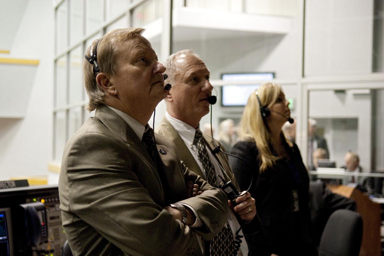 CAPE CANAVERAL, Fla. - From left, Mike Leinbach, shuttle launch director; Pete Nickolenko, assistant launch director; and Dana Hutcherson, flow director for space shuttle Endeavour, watch the liftoff of Endeavour through the windows of Firing Room 4 in the Launch Control Center at NASA's Kennedy Space Center in Florida.  Launch of Endeavour on the STS-130 mission to the International Space Station was at 4:14 a.m. EST.  This was the second launch attempt for space shuttle Endeavour's STS-130 crew and the final scheduled space shuttle night launch.  The first attempt on Feb. 7 was scrubbed due to unfavorable weather. The primary payload for the STS-130 mission to the International Space Station is the Tranquility node, a pressurized module that will provide additional room for crew members and many of the station's life support and environmental control systems. Attached to one end of Tranquility is a cupola, a unique work area with six windows on its sides and one on top.  The cupola resembles a circular bay window and will provide a vastly improved view of the station's exterior. The multi-directional view will allow the crew to monitor spacewalks and docking operations, as well as provide a spectacular view of Earth and other celestial objects. The module was built in Turin, Italy, by Thales Alenia Space for the European Space Agency.  For information on the STS-130 mission and crew, visit http:__www.nasa.gov_mission_pages_shuttle_shuttlemissions_sts130_index.html.  Photo credit: NASA_Kim Shiflett