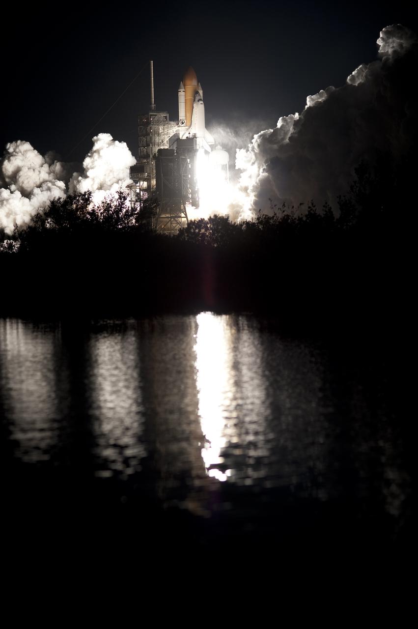 CAPE CANAVERAL, Fla. - Liftoff of space shuttle Endeavour is reflected in the still water near Launch Pad 39A at NASA's Kennedy Space Center in Florida. Launch of the STS-130 mission to the International Space Station was at 4:14 a.m. EST. This was the second launch attempt for space shuttle Endeavour's STS-130 crew and the final scheduled space shuttle night launch. The first attempt on Feb. 7 was scrubbed due to unfavorable weather. The primary payload for the STS-130 mission to the International Space Station is the Tranquility node, a pressurized module that will provide additional room for crew members and many of the station's life support and environmental control systems. Attached to one end of Tranquility is a cupola, a unique work area with six windows on its sides and one on top. The cupola resembles a circular bay window and will provide a vastly improved view of the station's exterior. The multi-directional view will allow the crew to monitor spacewalks and docking operations, as well as provide a spectacular view of Earth and other celestial objects. The module was built in Turin, Italy, by Thales Alenia Space for the European Space Agency. For information on the STS-130 mission and crew, visit http:__www.nasa.gov_mission_pages_shuttle_shuttlemissions_sts130_index.html. Photo credit: NASA_Tony Gray and Tom Farrar Sr.