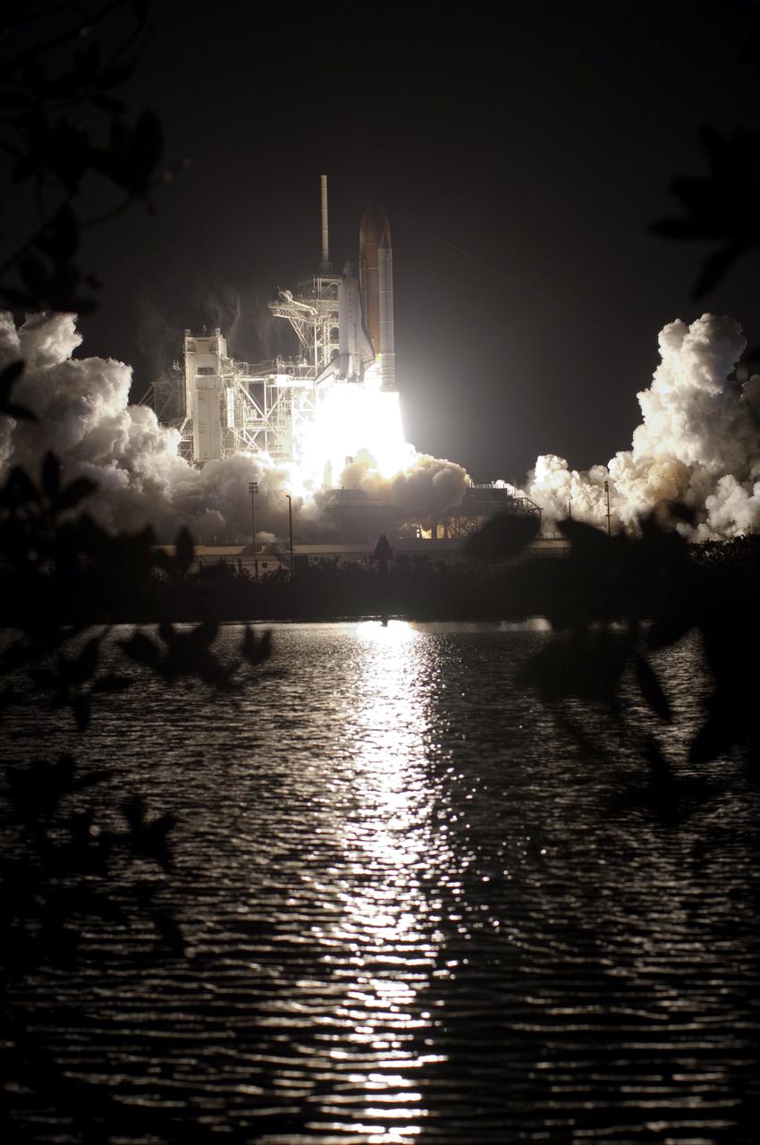 CAPE CANAVERAL, Fla. - Liftoff of space shuttle Endeavour is reflected in the still water near Launch Pad 39A at NASA's Kennedy Space Center in Florida. Launch of the STS-130 mission to the International Space Station was at 4:14 a.m. EST. This was the second launch attempt for space shuttle Endeavour's STS-130 crew and the final scheduled space shuttle night launch. The first attempt on Feb. 7 was scrubbed due to unfavorable weather. The primary payload for the STS-130 mission to the International Space Station is the Tranquility node, a pressurized module that will provide additional room for crew members and many of the station's life support and environmental control systems. Attached to one end of Tranquility is a cupola, a unique work area with six windows on its sides and one on top. The cupola resembles a circular bay window and will provide a vastly improved view of the station's exterior. The multi-directional view will allow the crew to monitor spacewalks and docking operations, as well as provide a spectacular view of Earth and other celestial objects. The module was built in Turin, Italy, by Thales Alenia Space for the European Space Agency. For information on the STS-130 mission and crew, visit http:__www.nasa.gov_mission_pages_shuttle_shuttlemissions_sts130_index.html. Photo credit: NASA_Tony Gray and Tom Farrar Sr.