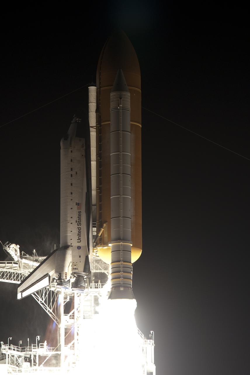 CAPE CANAVERAL, Fla. - Producing about 3 million pounds of thrust, this solid rocket booster does its part to lift space shuttle Endeavour from Launch Pad 39A at NASA's Kennedy Space Center in Florida into the night sky. Launch of the STS-130 mission to the International Space Station was at 4:14 a.m. EST. This was the second launch attempt for space shuttle Endeavour's STS-130 crew and the final scheduled space shuttle night launch. The first attempt on Feb. 7 was scrubbed due to unfavorable weather. The primary payload for the STS-130 mission to the International Space Station is the Tranquility node, a pressurized module that will provide additional room for crew members and many of the station's life support and environmental control systems. Attached to one end of Tranquility is a cupola, a unique work area with six windows on its sides and one on top. The cupola resembles a circular bay window and will provide a vastly improved view of the station's exterior. The multi-directional view will allow the crew to monitor spacewalks and docking operations, as well as provide a spectacular view of Earth and other celestial objects. The module was built in Turin, Italy, by Thales Alenia Space for the European Space Agency. For information on the STS-130 mission and crew, visit http:__www.nasa.gov_mission_pages_shuttle_shuttlemissions_sts130_index.html. Photo credit: NASA_ Michael Gayle and Rusty Backer